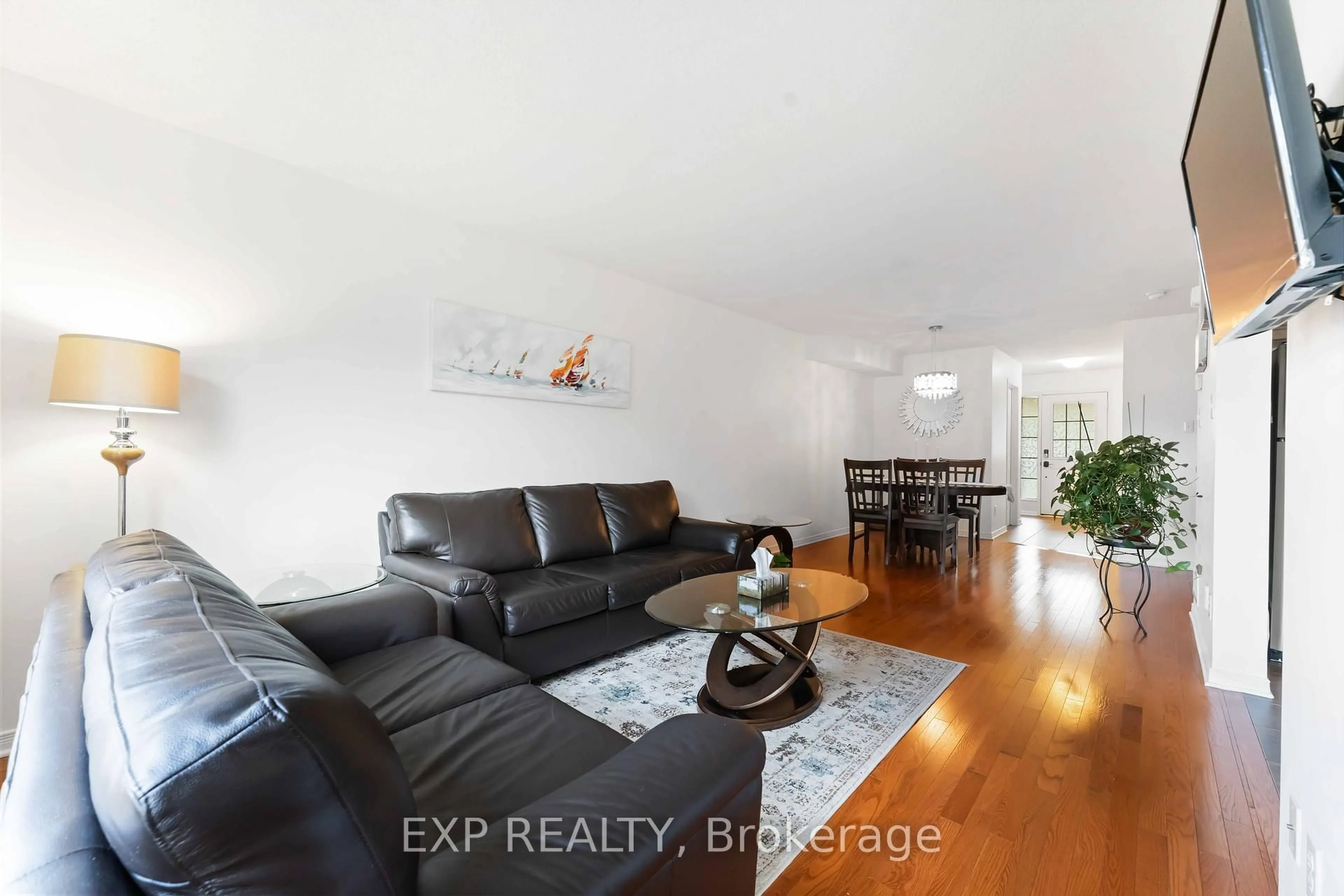 Living room with furniture, wood/laminate floor for 438 Haresfield Crt, Ottawa Ontario K4M 0B6