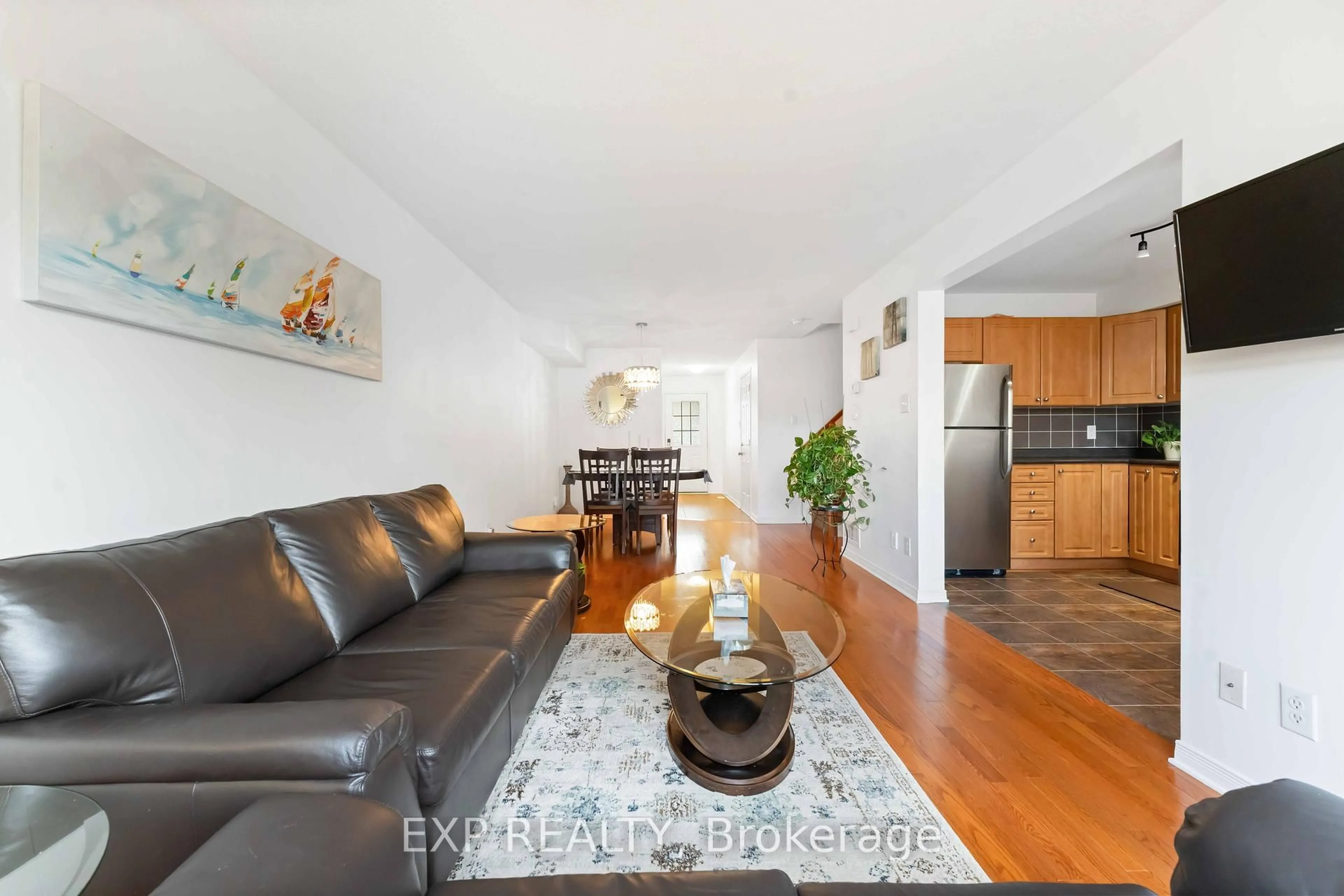 Living room with furniture, wood/laminate floor for 438 Haresfield Crt, Ottawa Ontario K4M 0B6