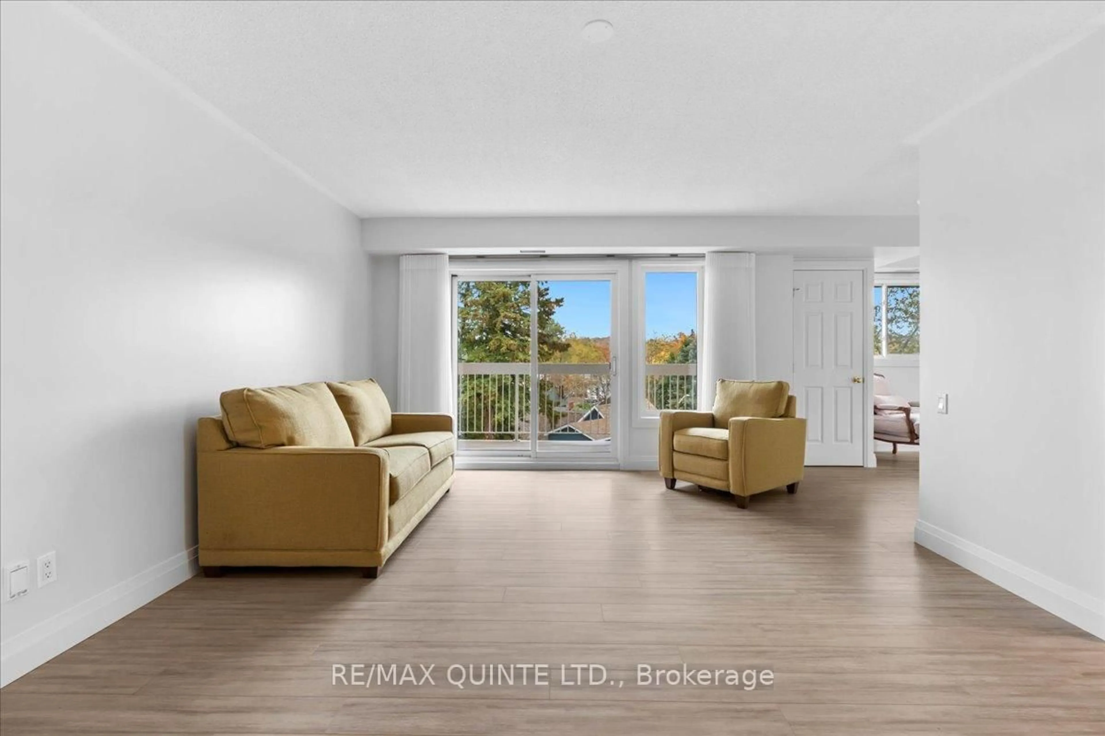 Living room with furniture, wood/laminate floor for 8 Talbot St #321, Prince Edward County Ontario K0K 2T0