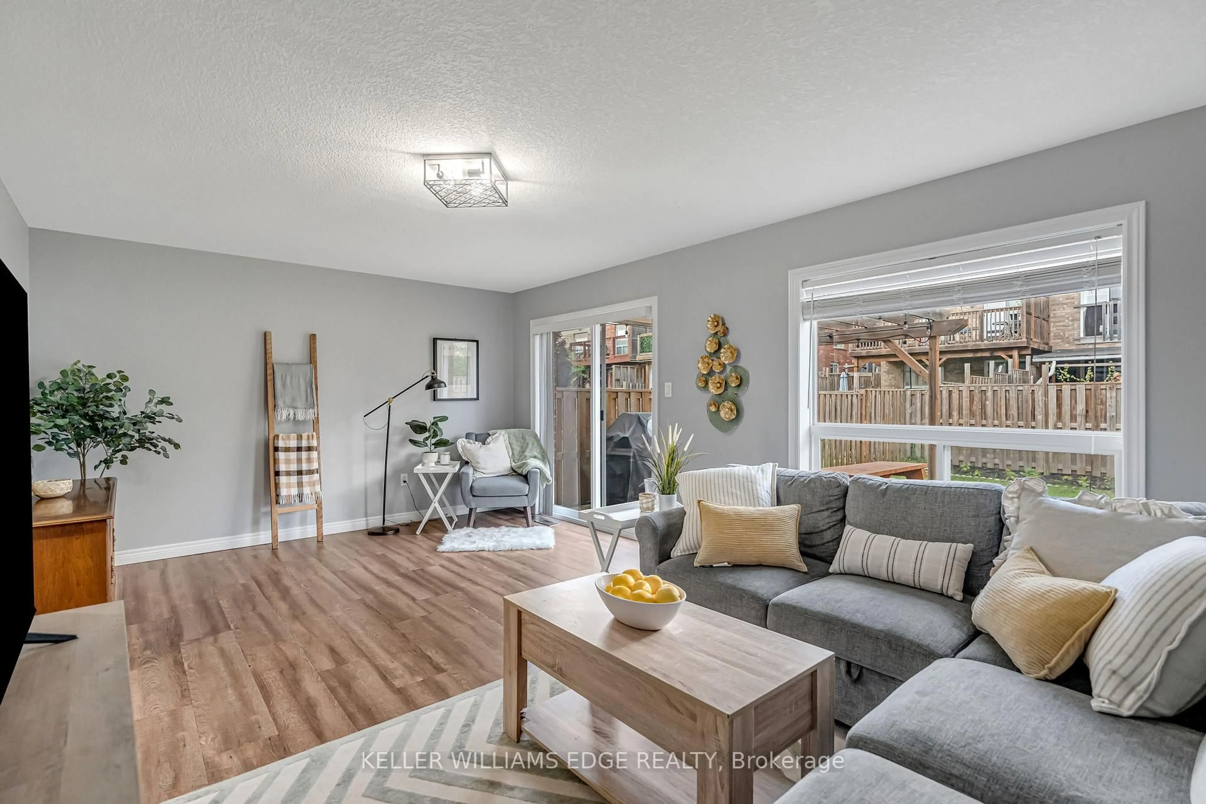 Living room with furniture, wood/laminate floor for 19 Oakes Cres, Guelph Ontario N1E 0J6