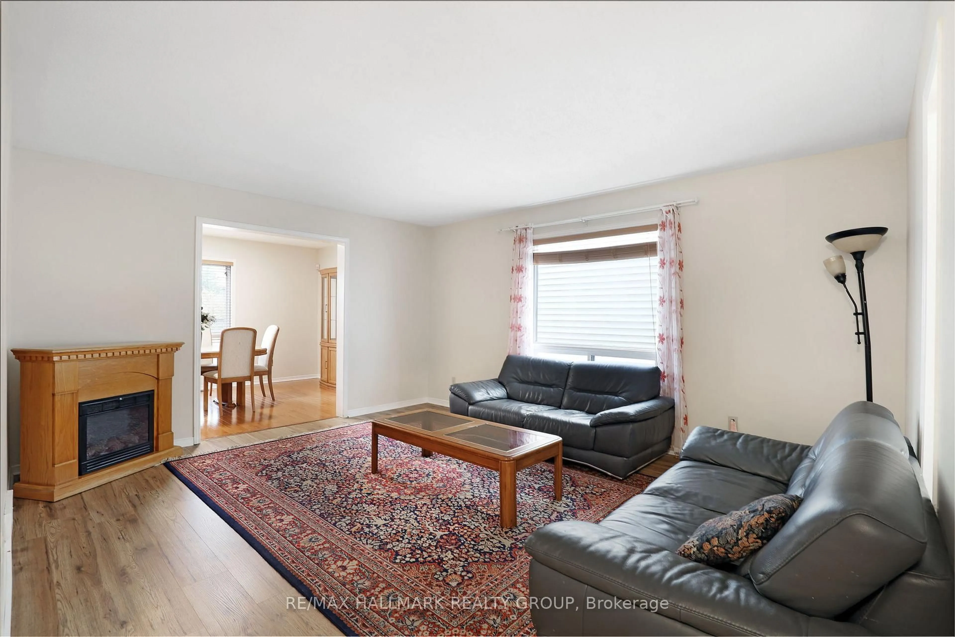 Living room with furniture, wood/laminate floor for 6 Robina Ave, Ottawa Ontario K2H 9R3