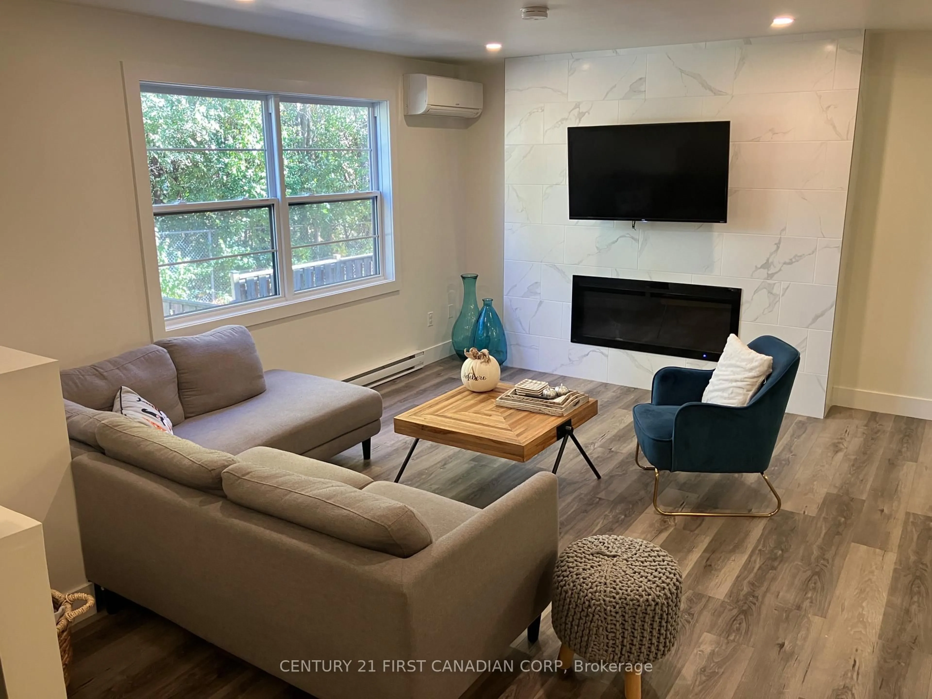 Living room with furniture, wood/laminate floor for 105 Andover Dr #36, London South Ontario N6J 4B1