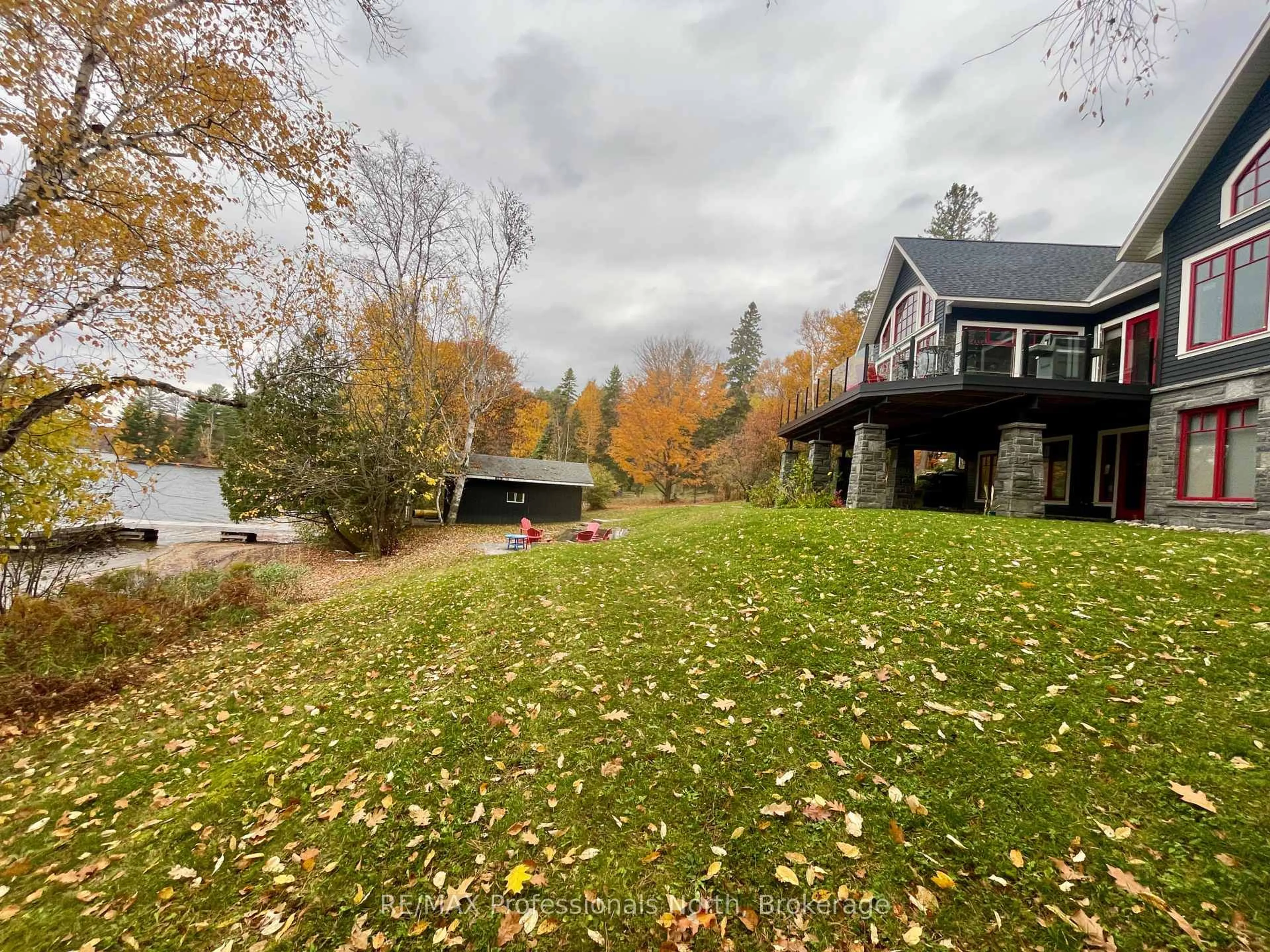 A pic from outside/outdoor area/front of a property/back of a property/a pic from drone, water/lake/river/ocean view for 11 Tipper Lane, Huntsville Ontario P1H 2J2