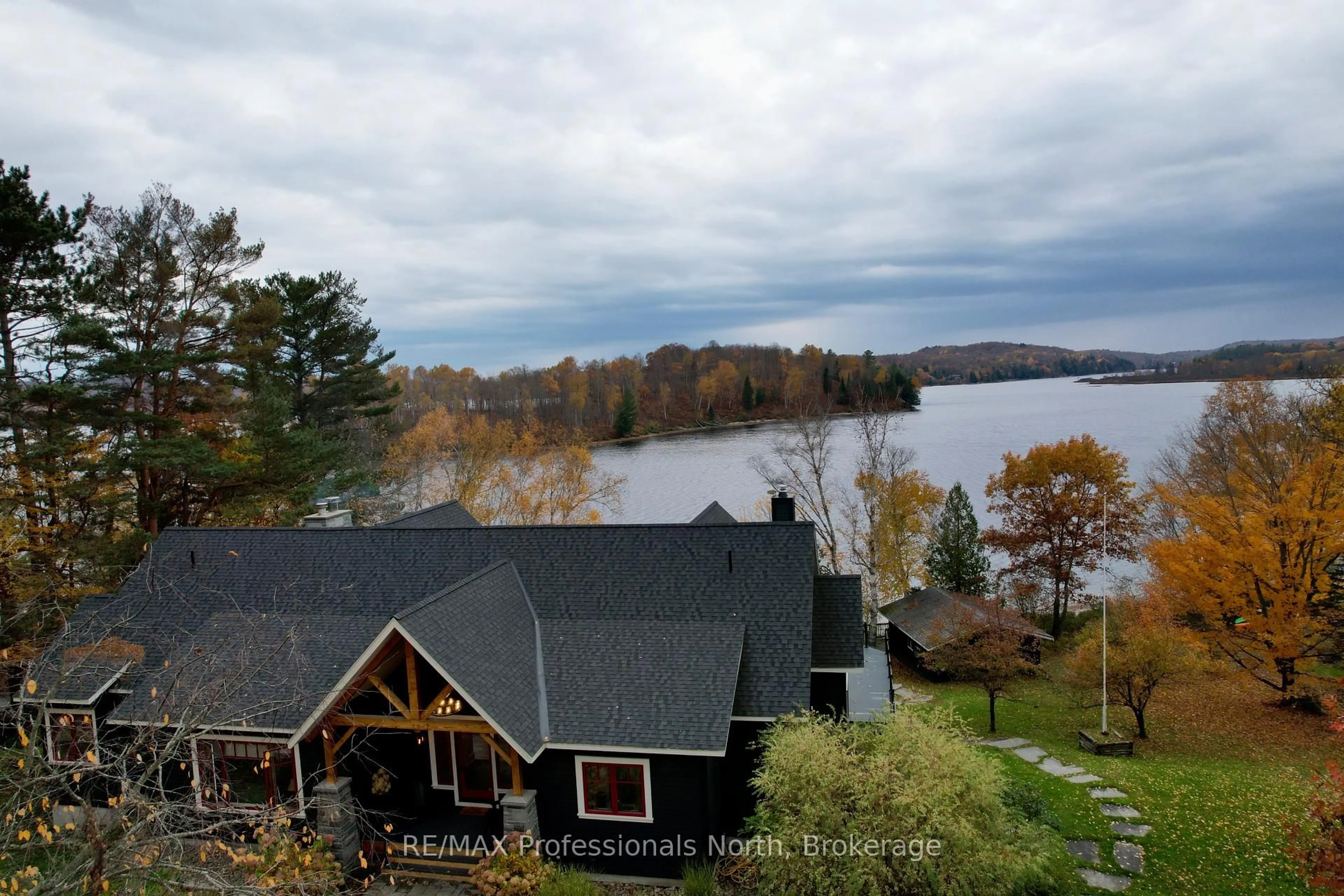 A pic from outside/outdoor area/front of a property/back of a property/a pic from drone, water/lake/river/ocean view for 11 Tipper Lane, Huntsville Ontario P1H 2J2