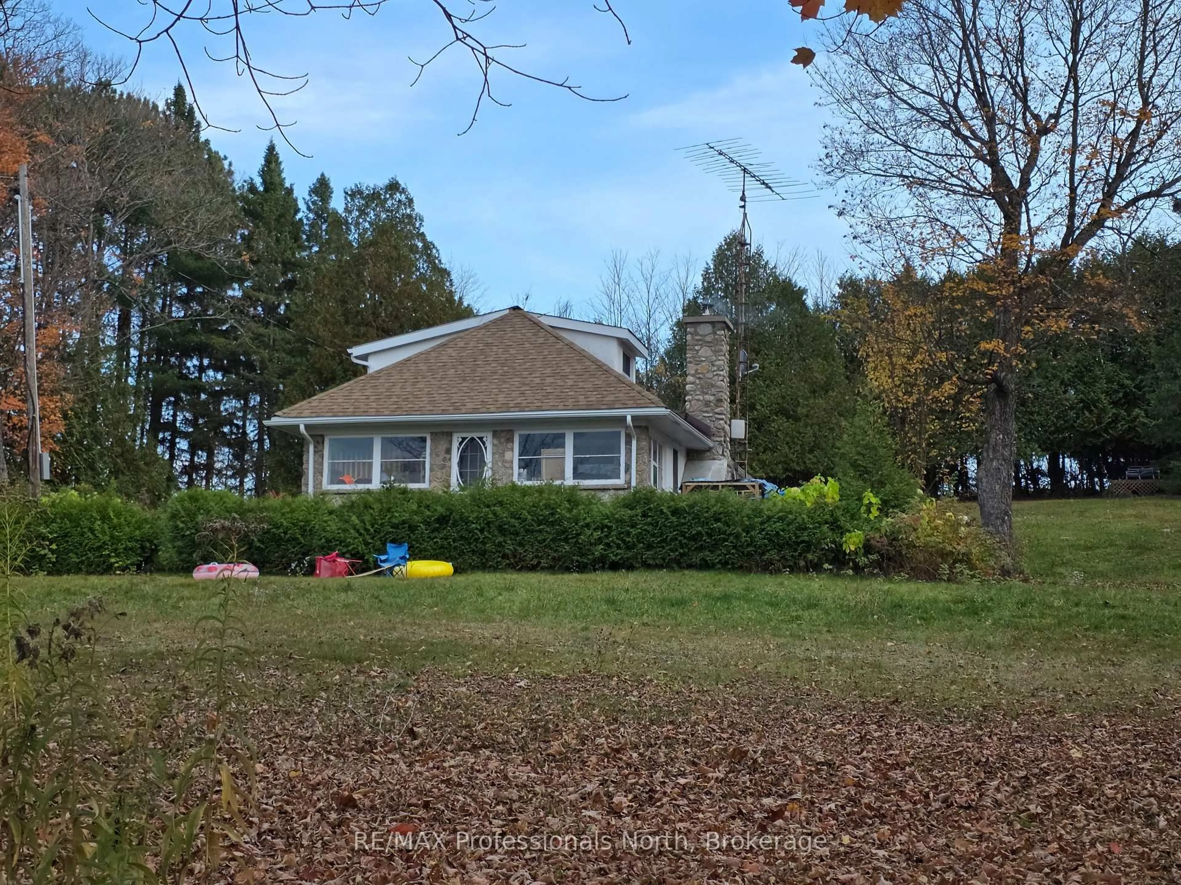 A pic from outside/outdoor area/front of a property/back of a property/a pic from drone, forest/trees view for 10416 Highway 118, Algonquin Highlands Ontario K0M 1S0