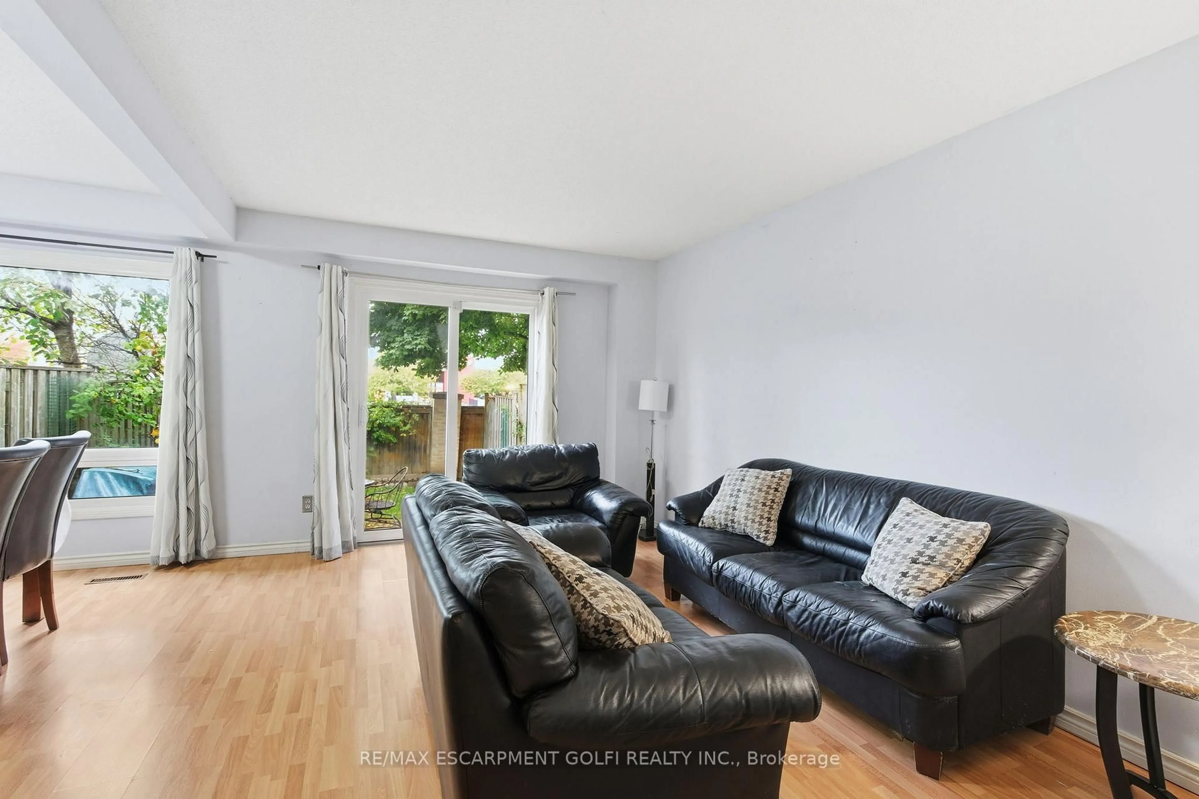 Living room with furniture, wood/laminate floor for 15 Derby St #12, Hamilton Ontario L8W 3T3