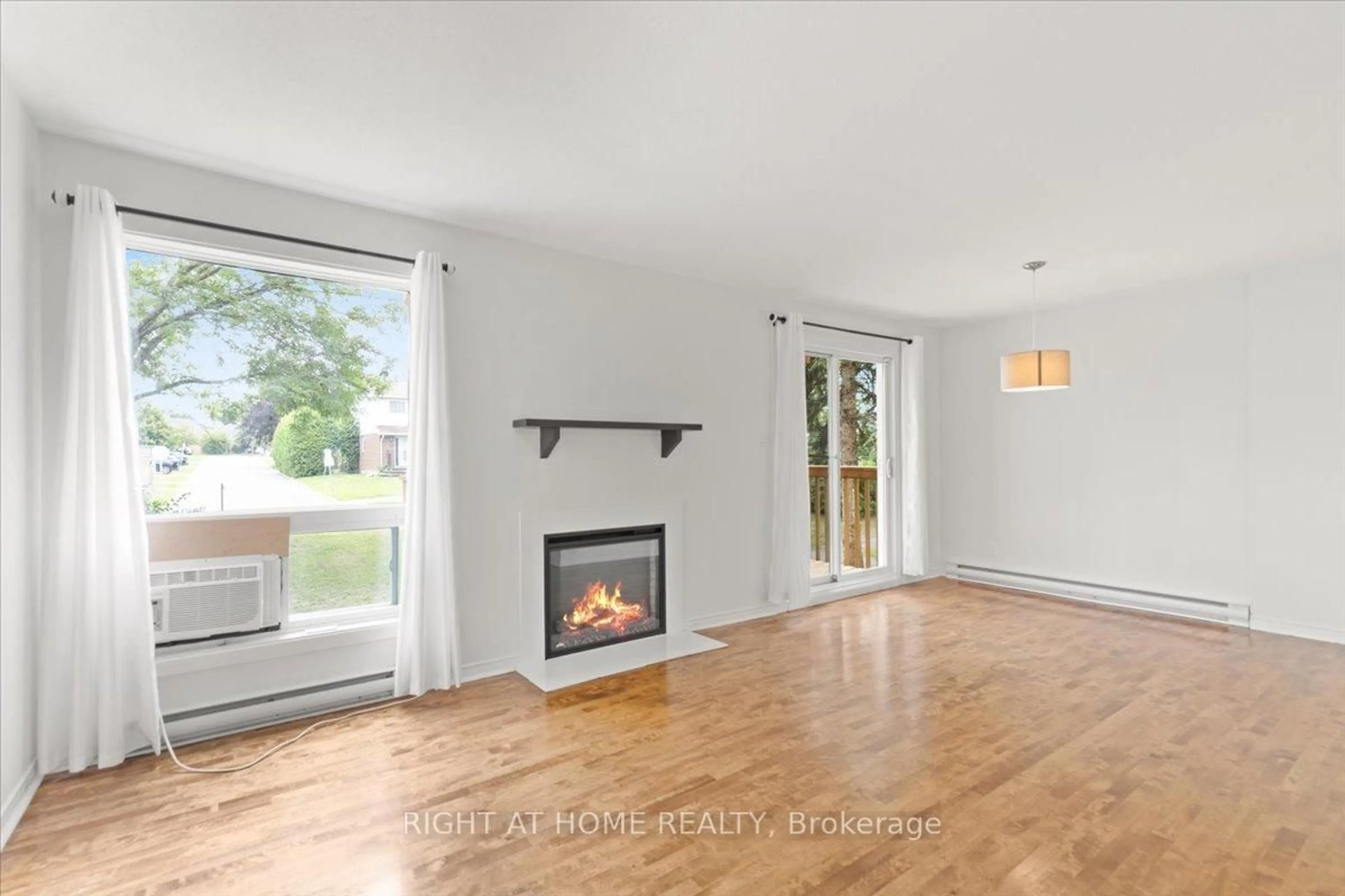 Living room with furniture, wood/laminate floor for 520 Fenerty Crt #3, Ottawa Ontario K2L 3B1