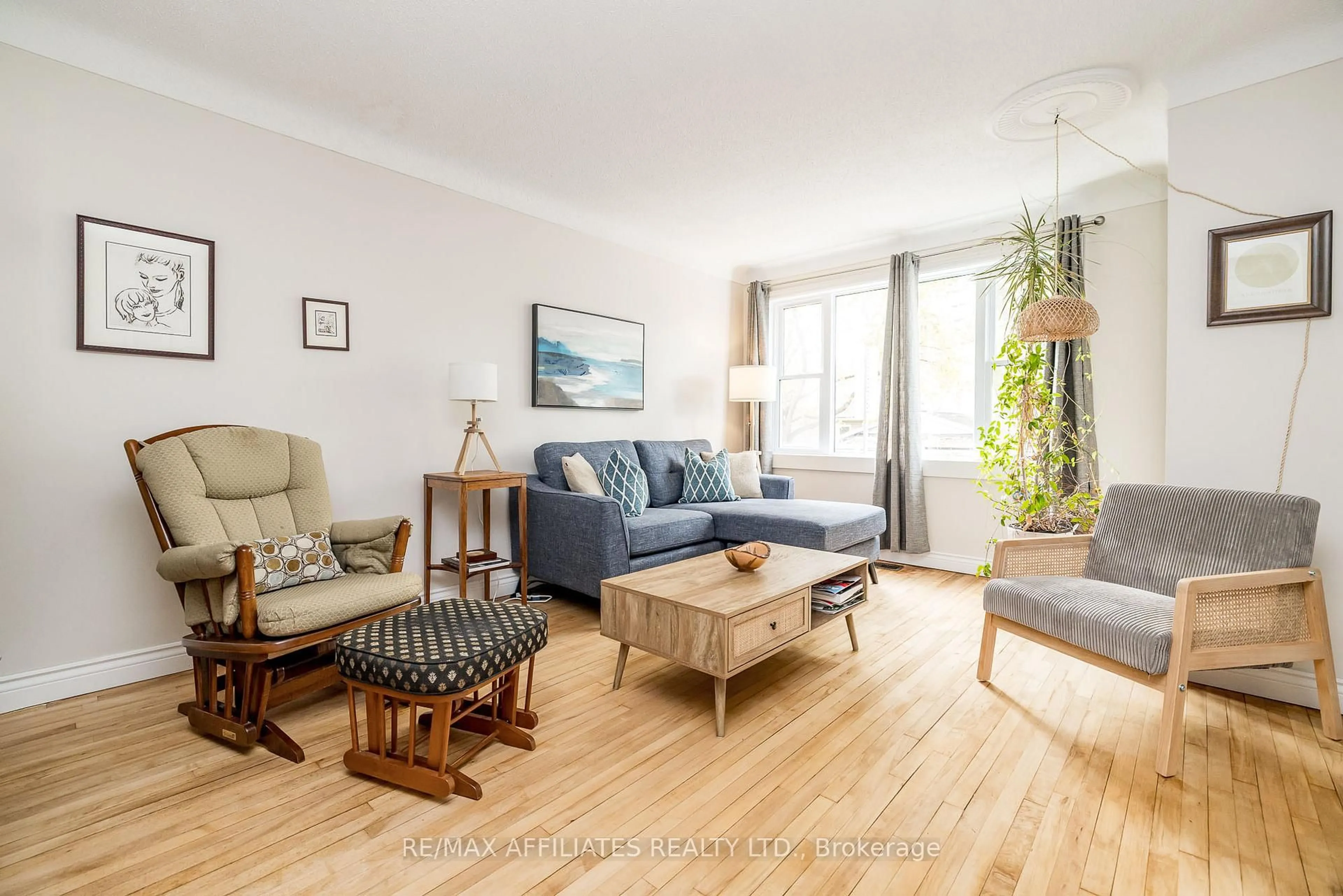 Living room with furniture, wood/laminate floor for 361 Larouche St, Ottawa Ontario K1L 7L1