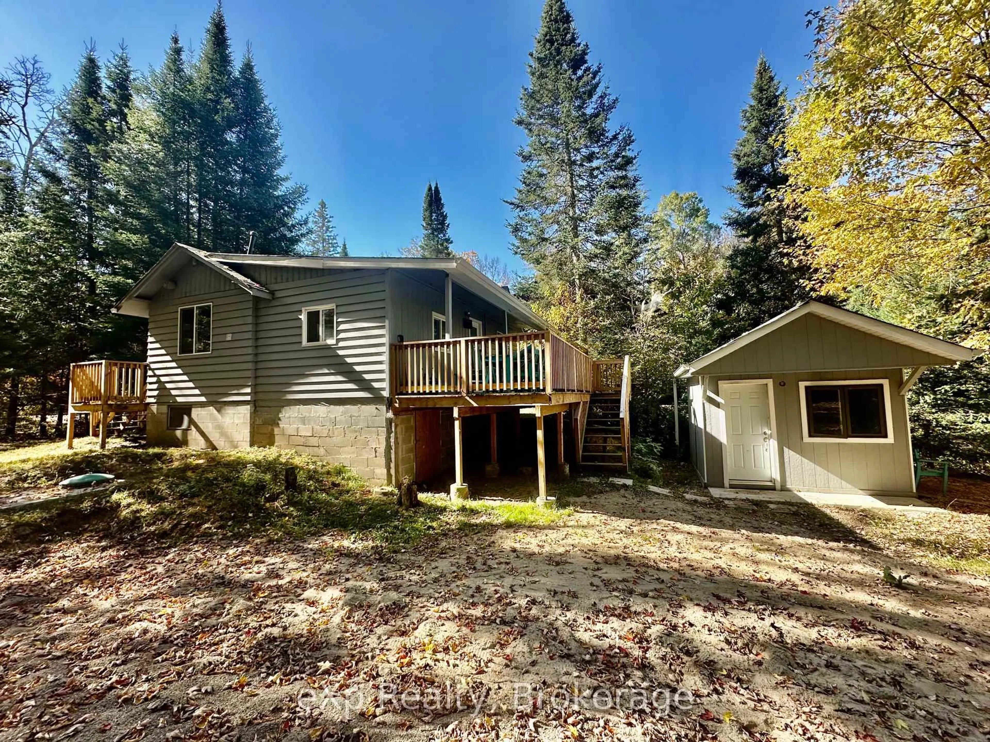 A pic from outside/outdoor area/front of a property/back of a property/a pic from drone, forest/trees view for 61 Robert Rd, Huntsville Ontario P1H 1L4