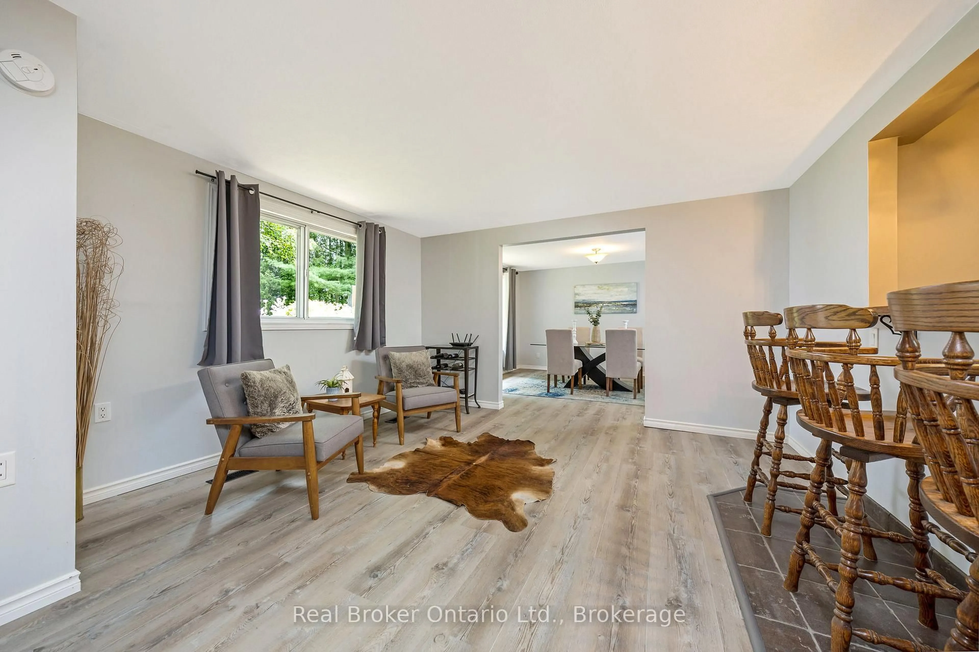 Living room with furniture, wood/laminate floor for 111016 11th Line, East Garafraxa Ontario L9W 7A4