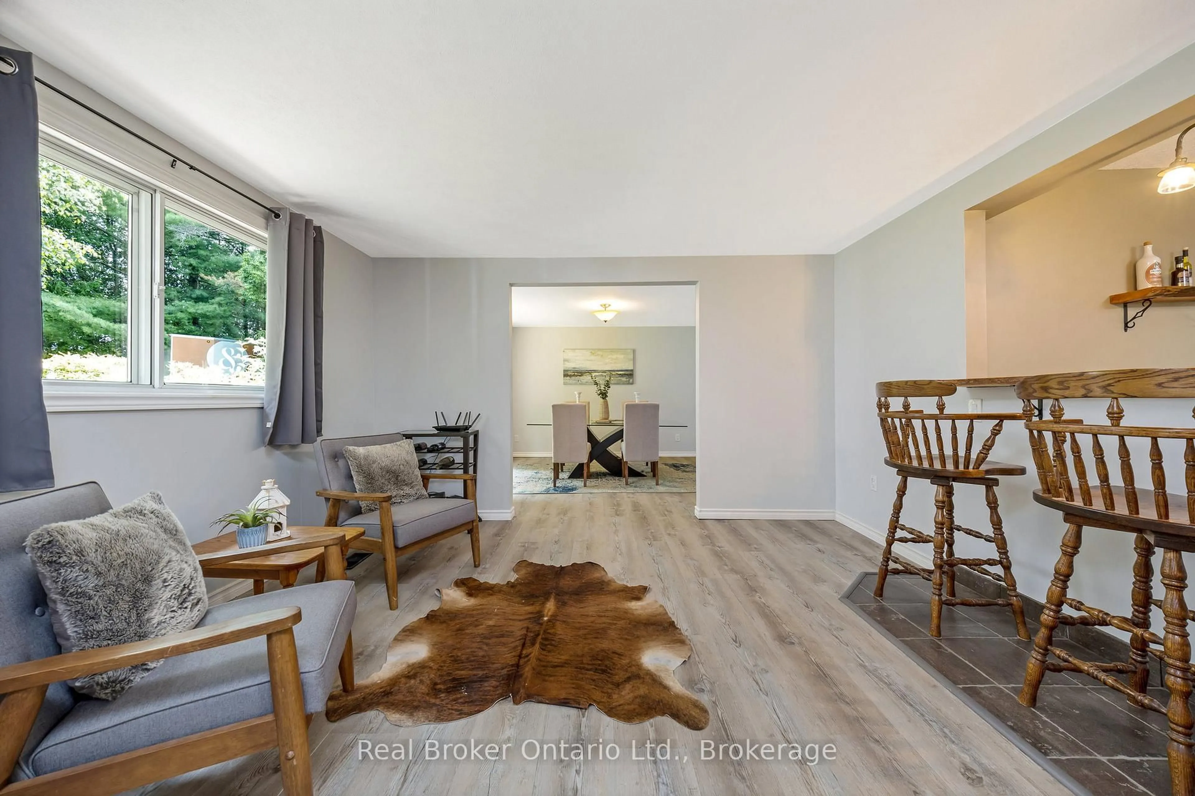 Living room with furniture, wood/laminate floor for 111016 11th Line, East Garafraxa Ontario L9W 7A4