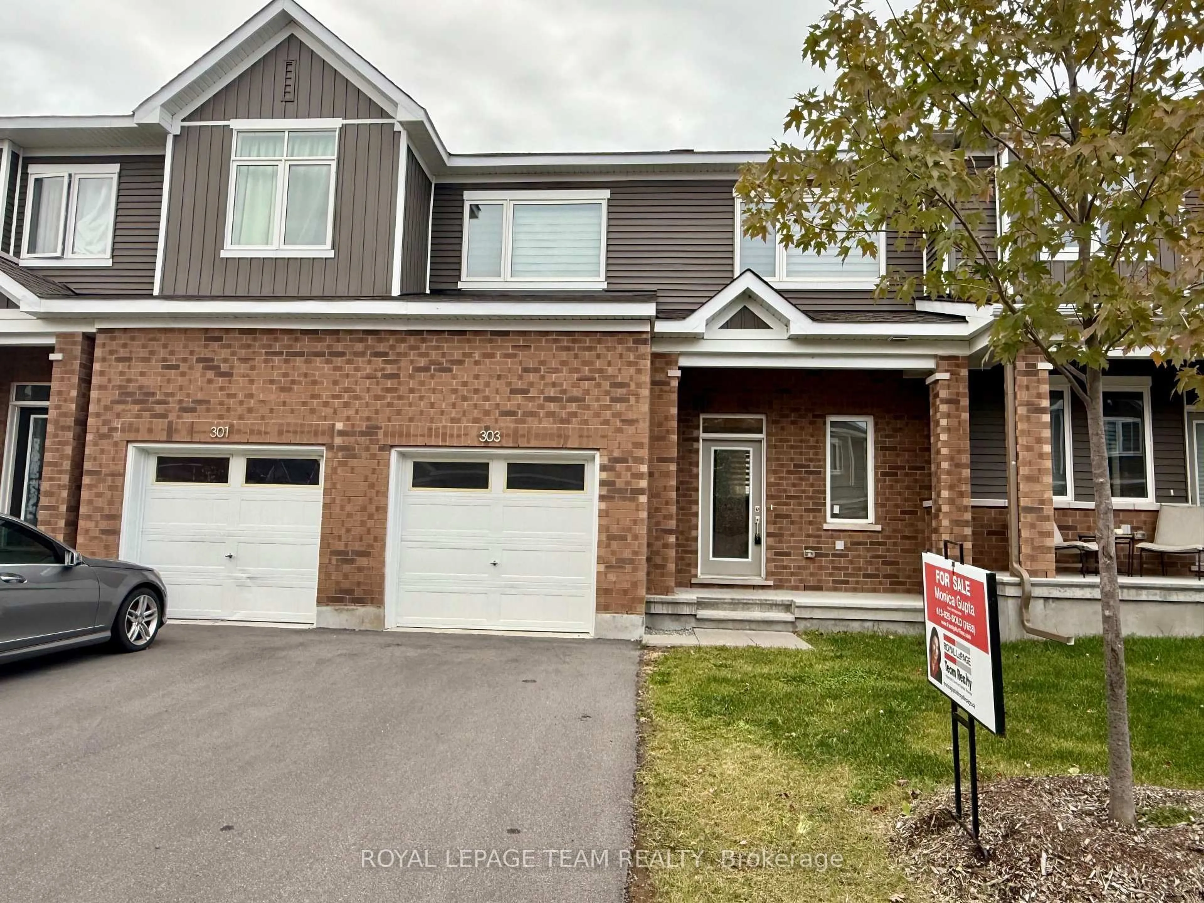 Home with brick exterior material, street for 303 Canadensis Lane, Ottawa Ontario K2J 6X8