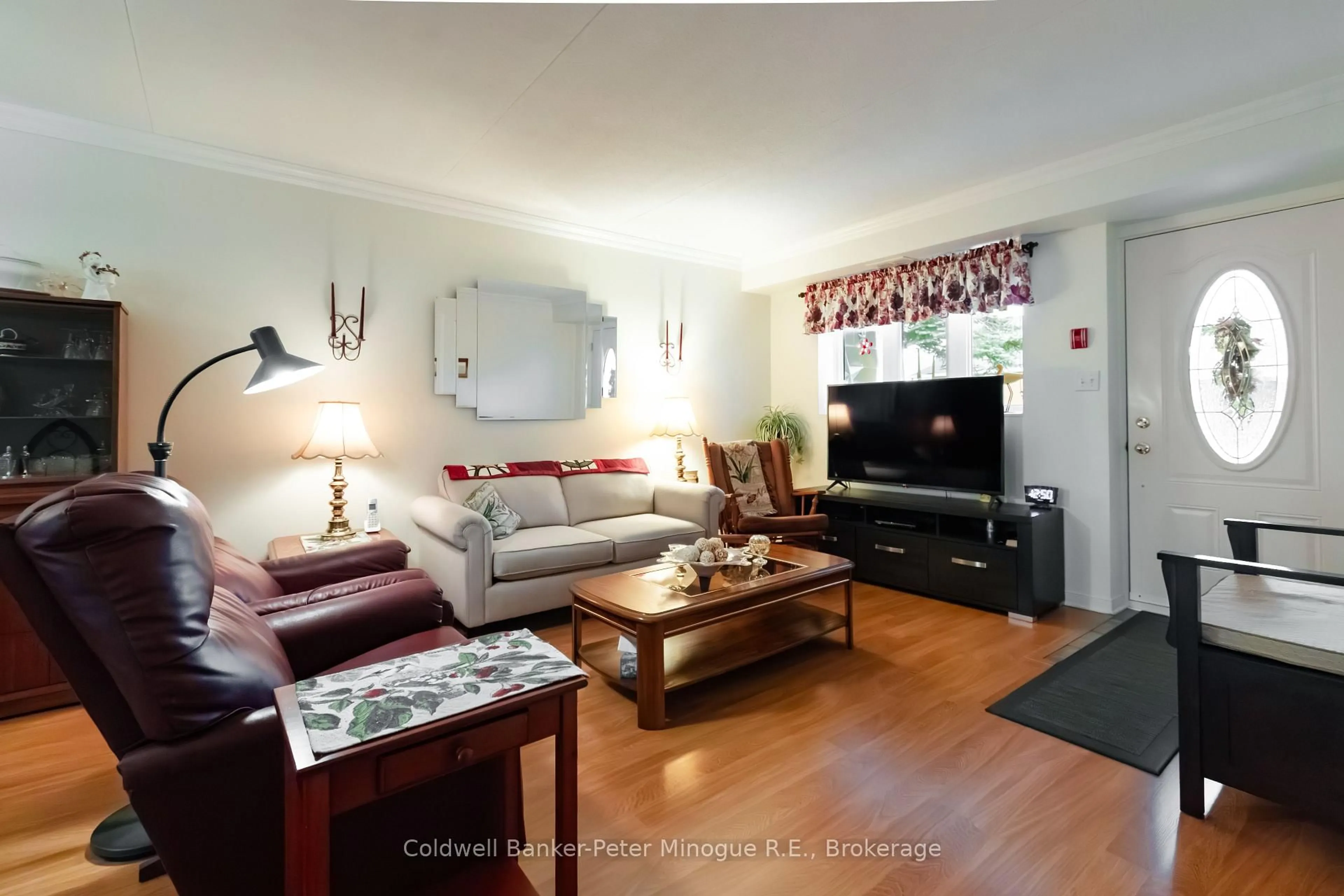 Living room with furniture, wood/laminate floor for 880 Regina St #103, North Bay Ontario P1B 2K6
