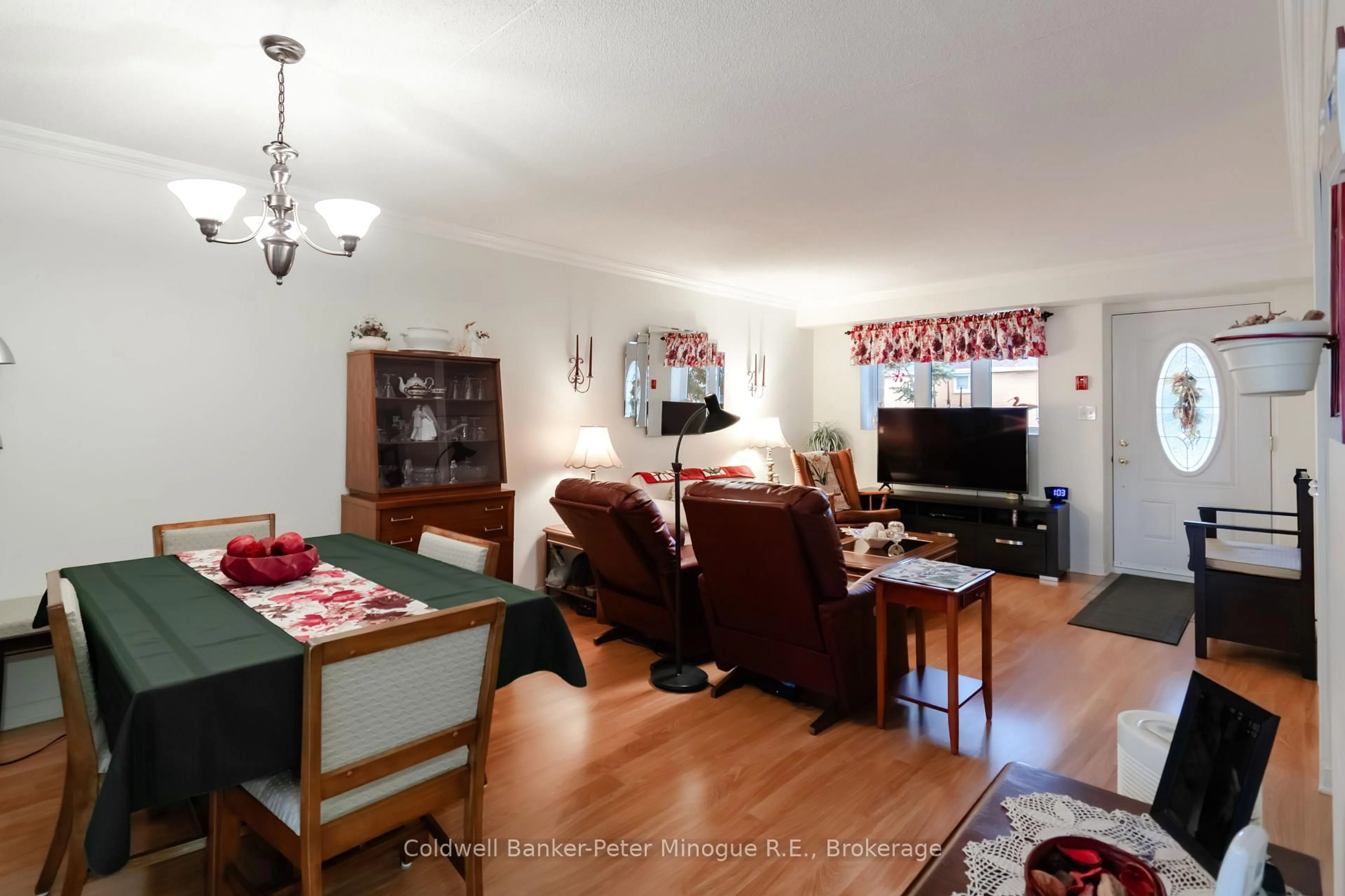 Living room with furniture, wood/laminate floor for 880 Regina St #103, North Bay Ontario P1B 2K6