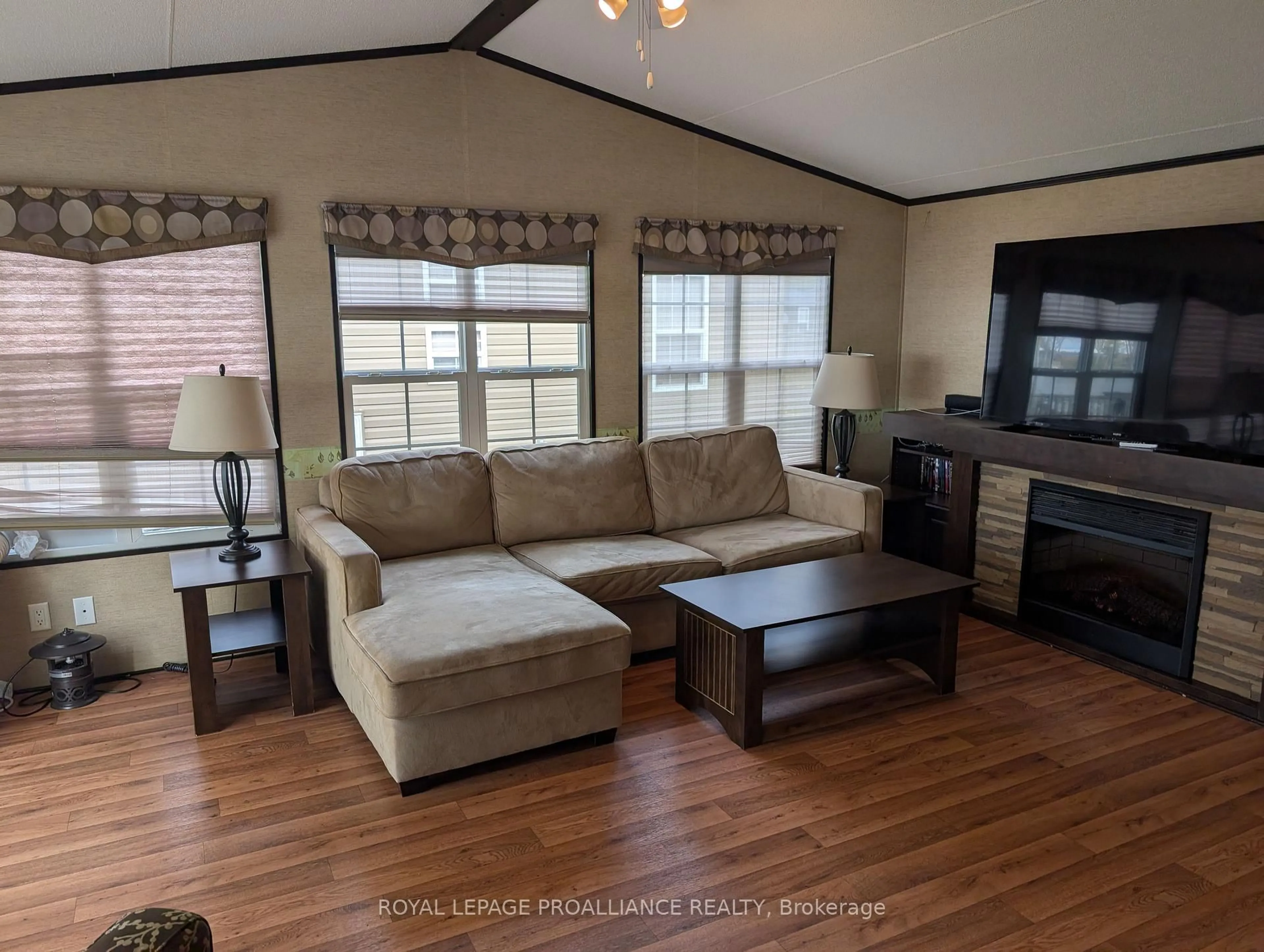 Living room with furniture, wood/laminate floor for 486 Cty Rd 18- 7 Beachview Lane, Prince Edward County Ontario K0K 1P0