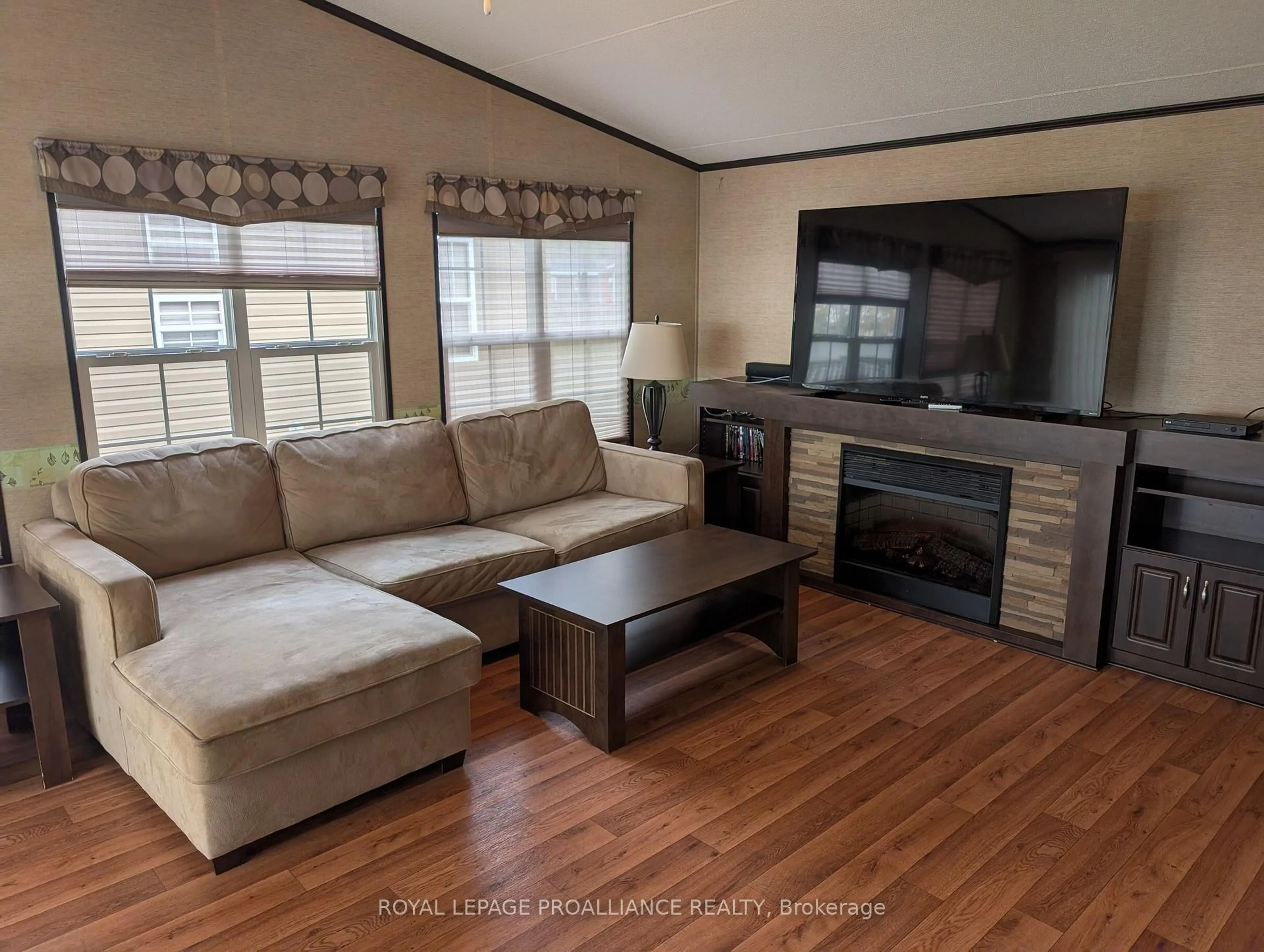 Living room with furniture, wood/laminate floor for 486 Cty Rd 18- 7 Beachview Lane, Prince Edward County Ontario K0K 1P0