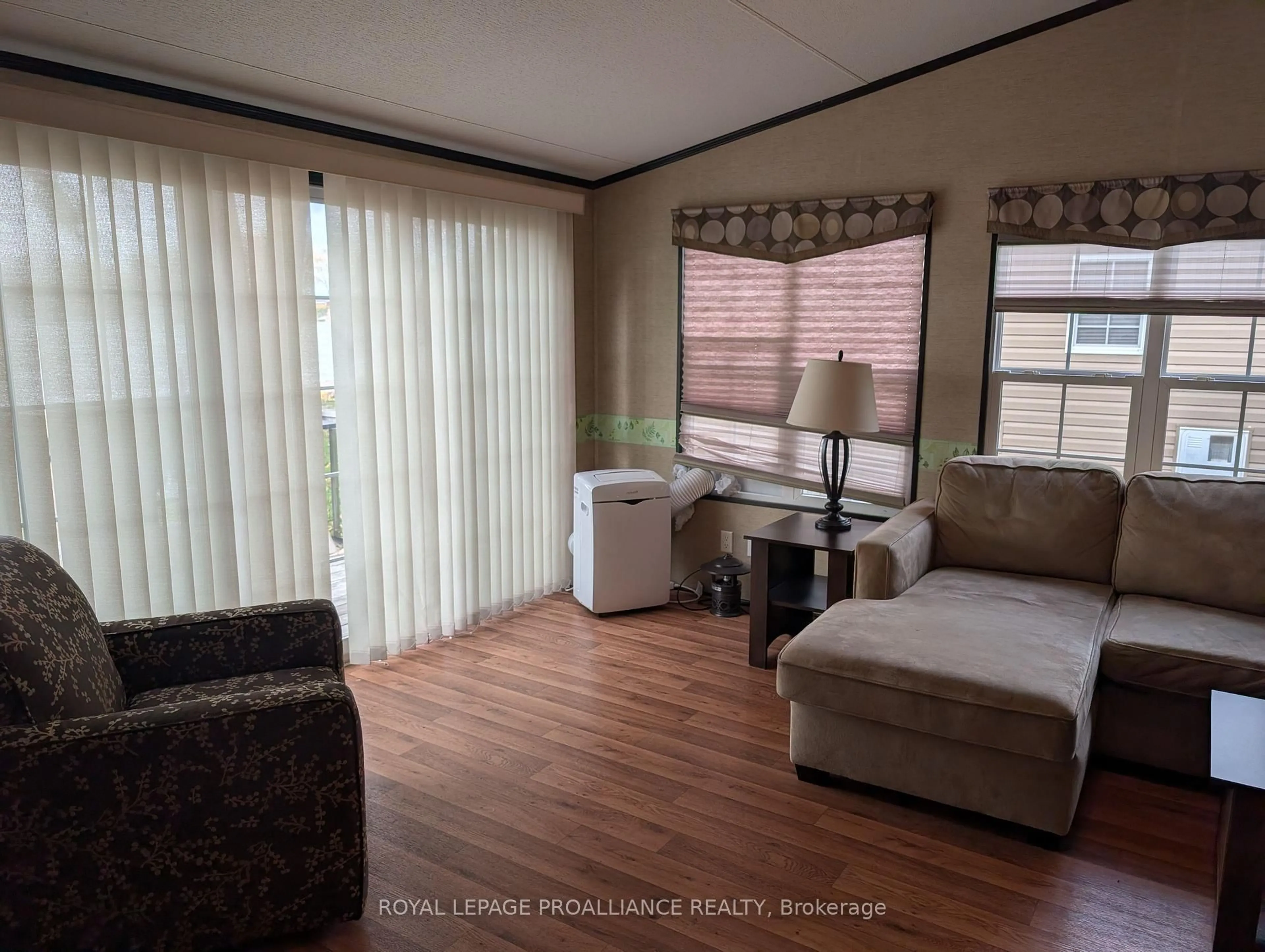 Living room with furniture, wood/laminate floor for 486 Cty Rd 18- 7 Beachview Lane, Prince Edward County Ontario K0K 1P0