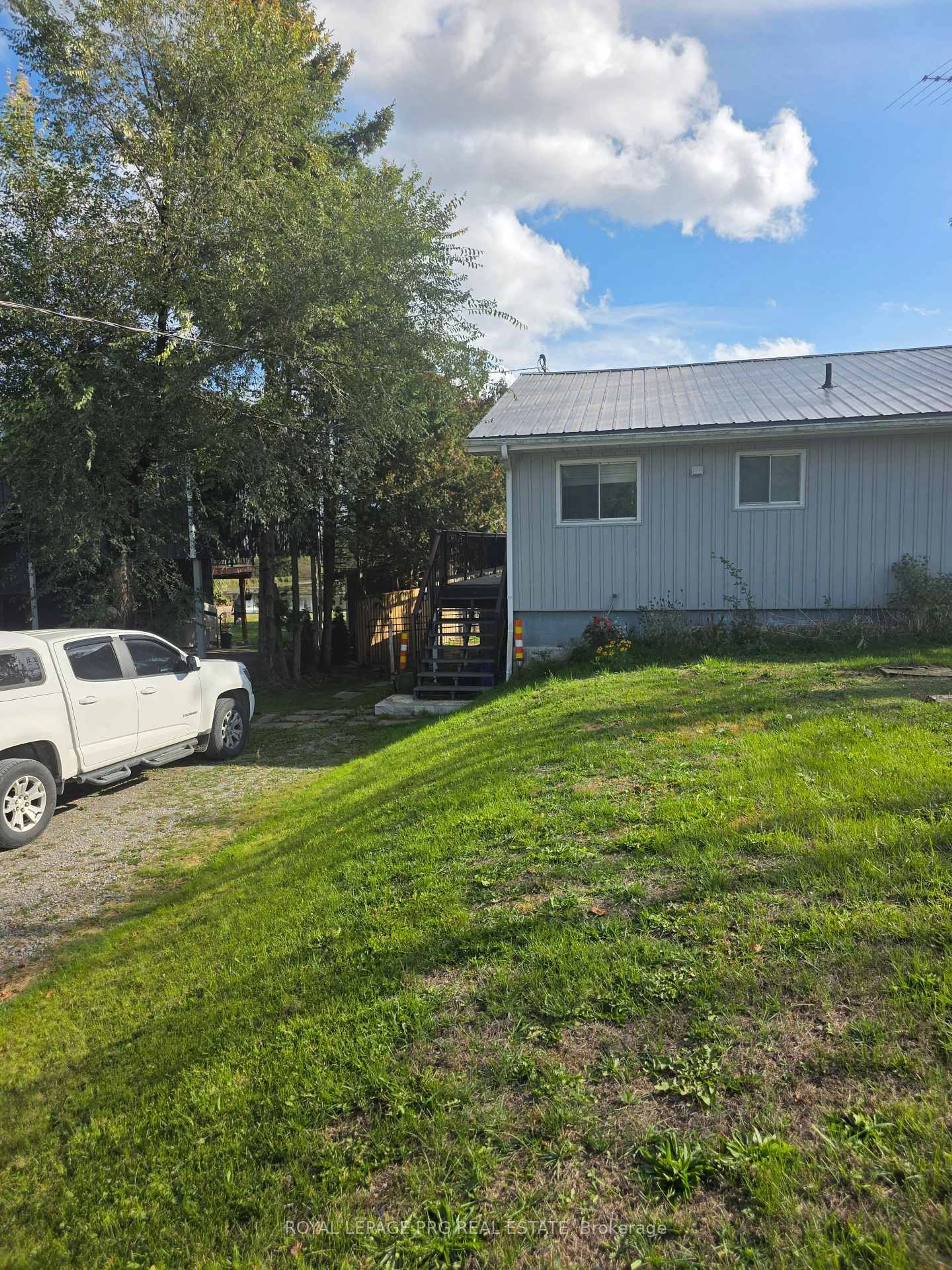 A pic from outside/outdoor area/front of a property/back of a property/a pic from drone, street for 183 McGuire Beach Rd, Kawartha Lakes Ontario K0M 2B0