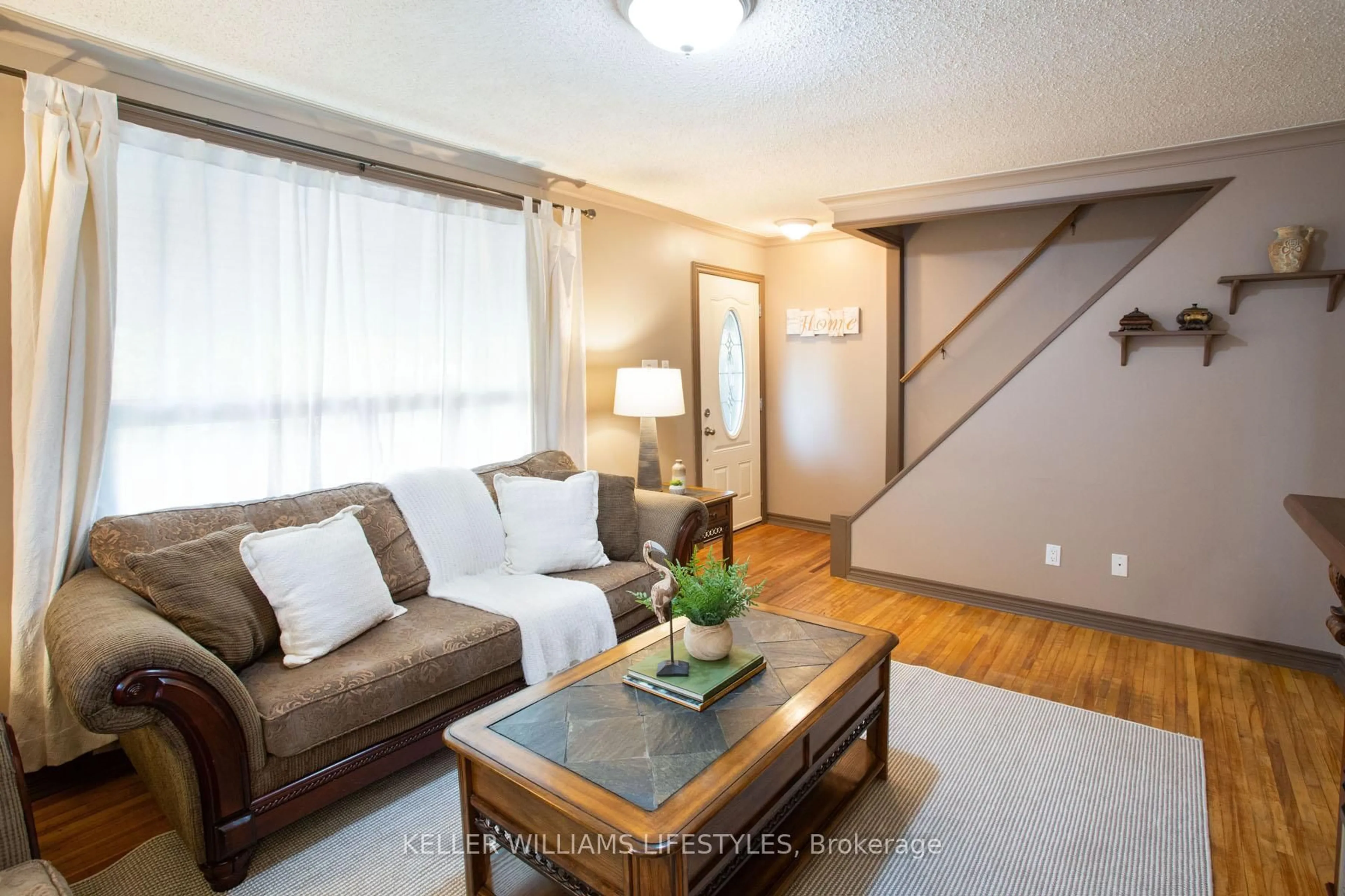 Living room with furniture, wood/laminate floor for 315 Fairview Ave, London South Ontario N6C 4V1