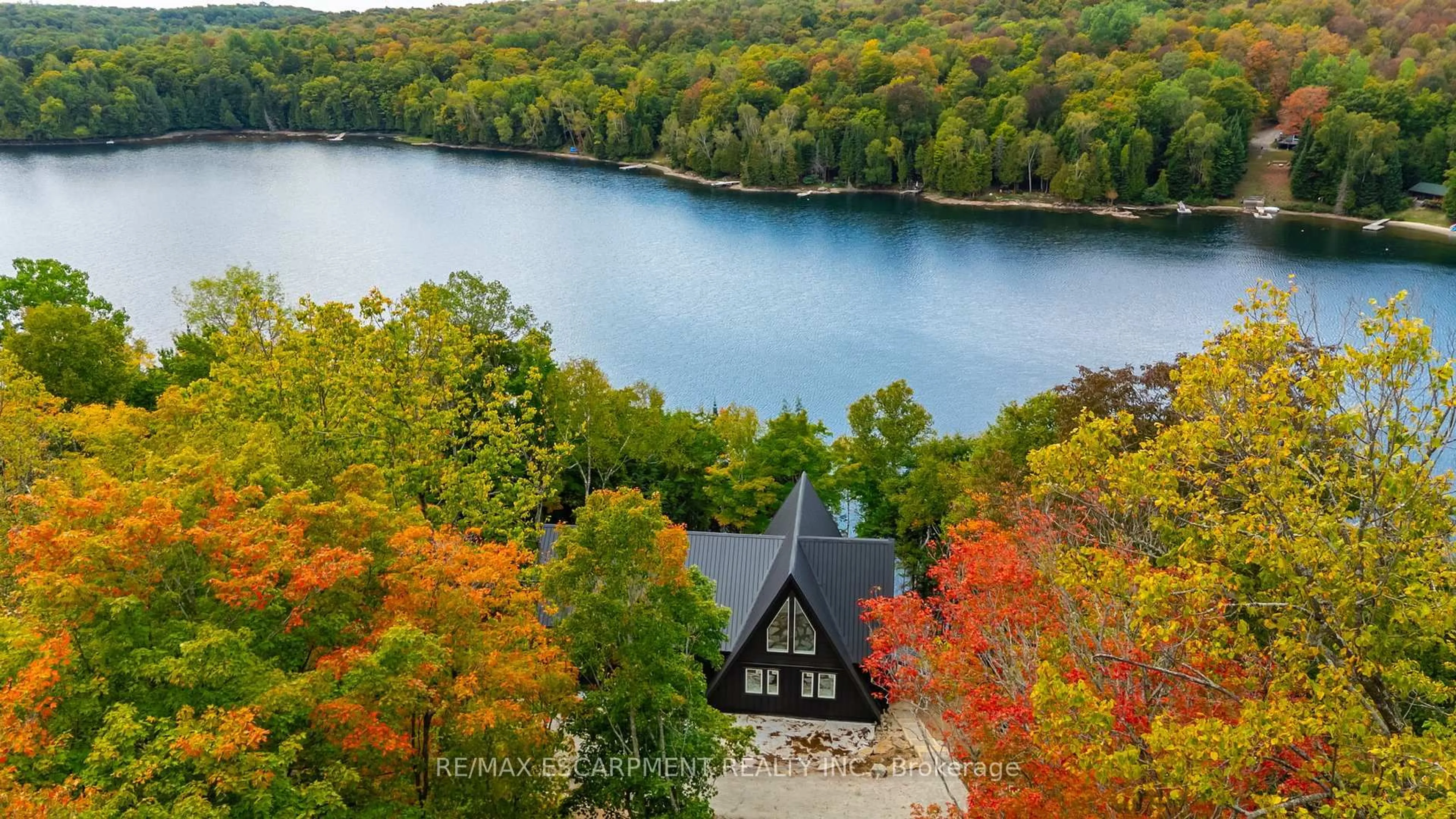 A pic from outside/outdoor area/front of a property/back of a property/a pic from drone, water/lake/river/ocean view for 1295 Wenona Lake Rd, Dysart et al Ontario K0M 1S0
