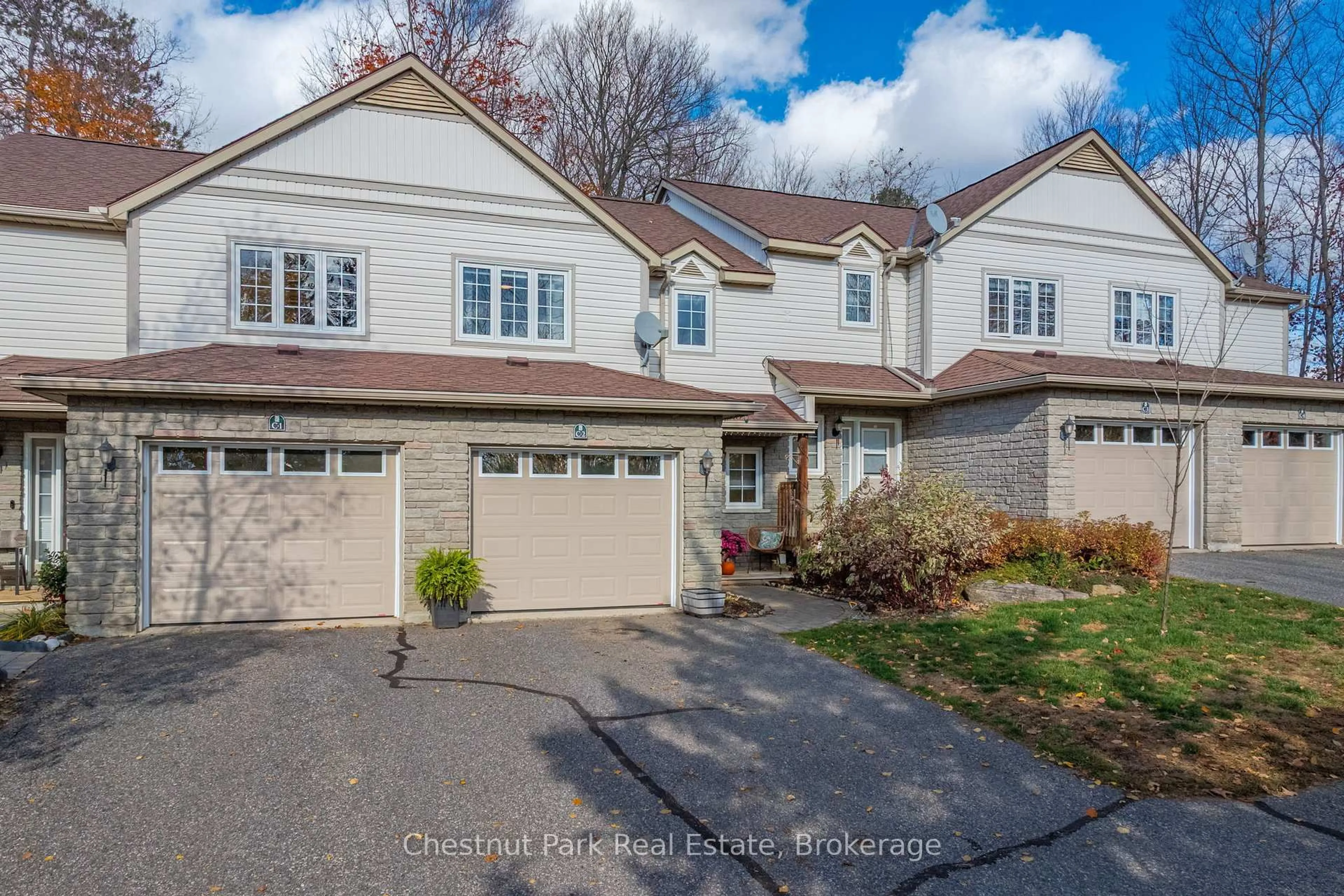 Home with vinyl exterior material, street for 20 Dairy Lane #C2, Huntsville Ontario P1H 2L1