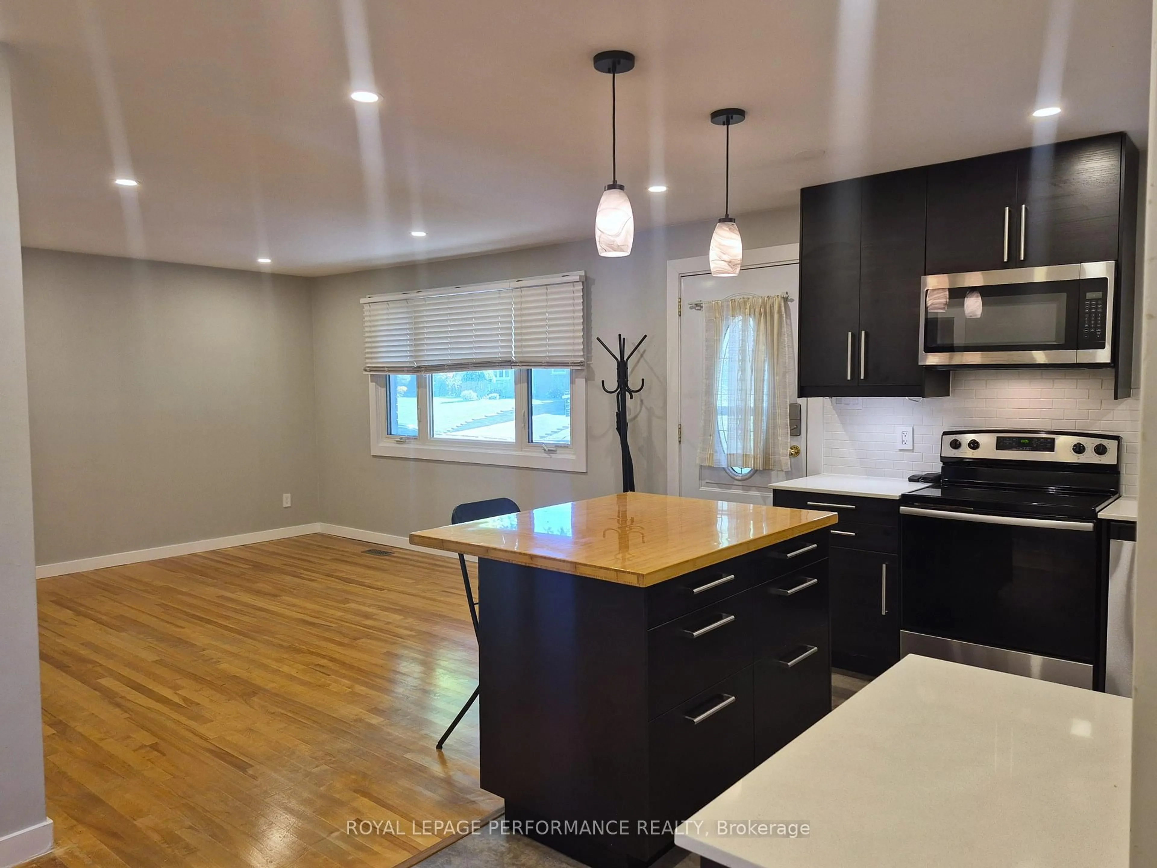 Open concept kitchen, wood/laminate floor for 2529 Roman Ave, Ottawa Ontario K2B 7X8