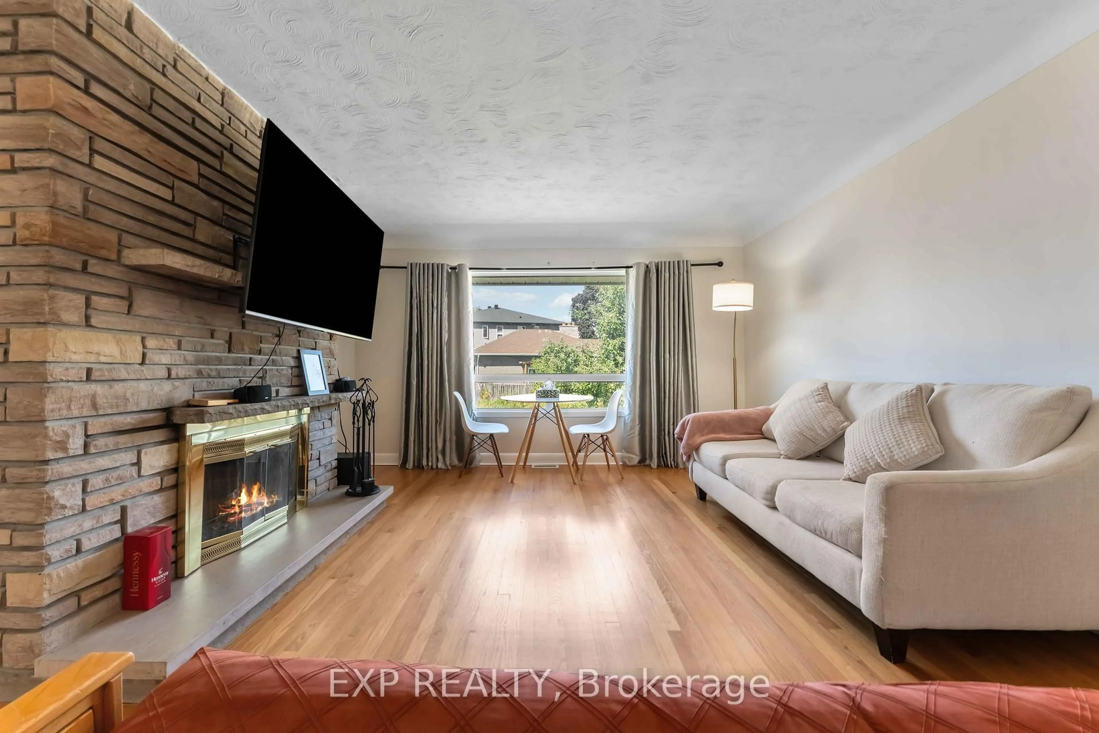 Living room with furniture, wood/laminate floor for 506 Vernon Ave, Ottawa Ontario K1K 1A6