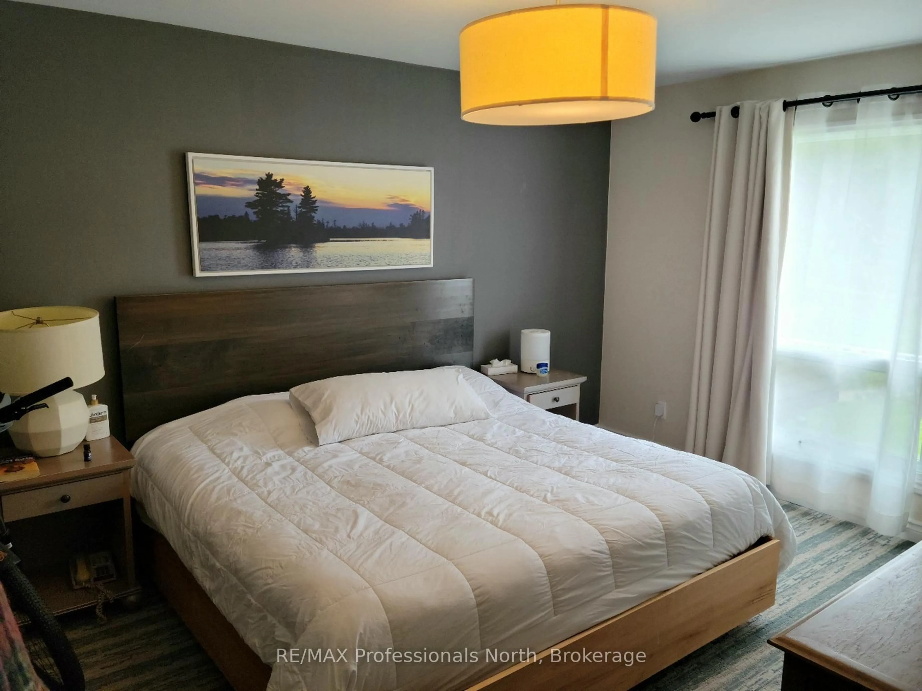 Bedroom with bed, wood/laminate floor for 1235 Deerhurst Dr #54-207, Huntsville Ontario P1H 2E8