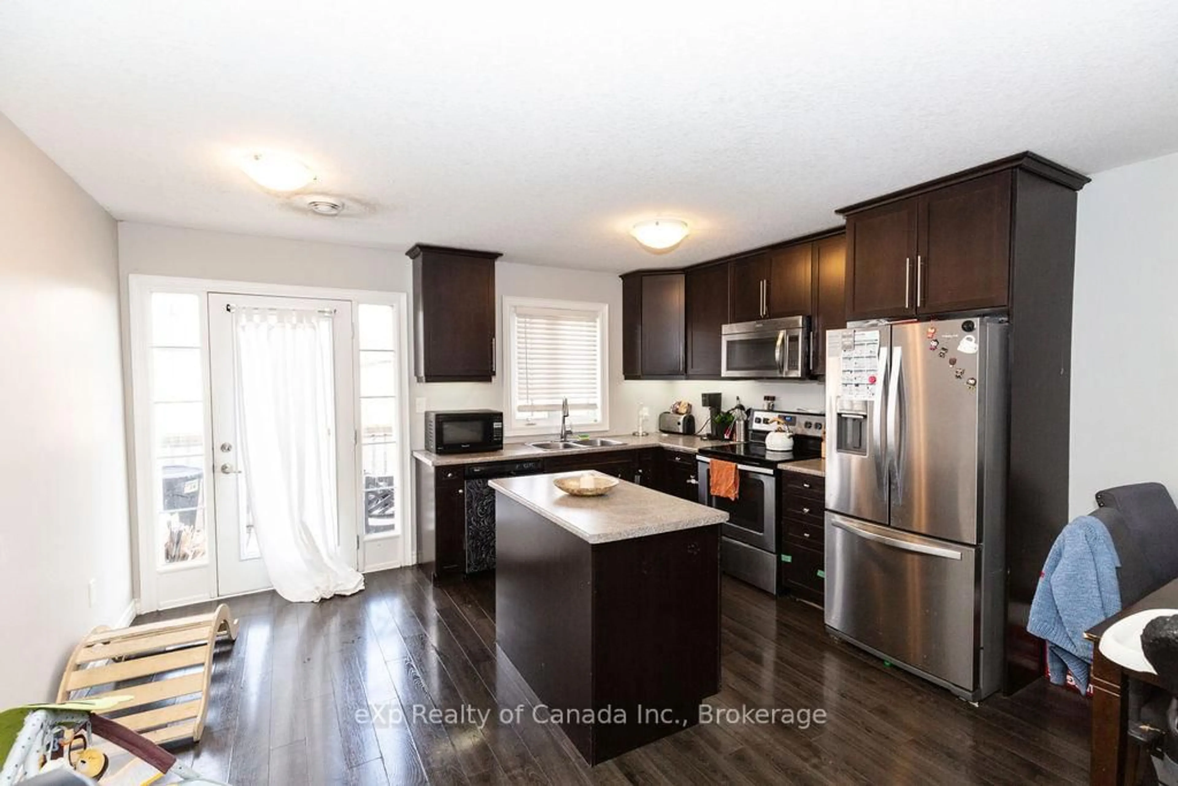 Open concept kitchen, wood/laminate floor for 3320 Meadowgate Blvd #72, London South Ontario N6M 0A7
