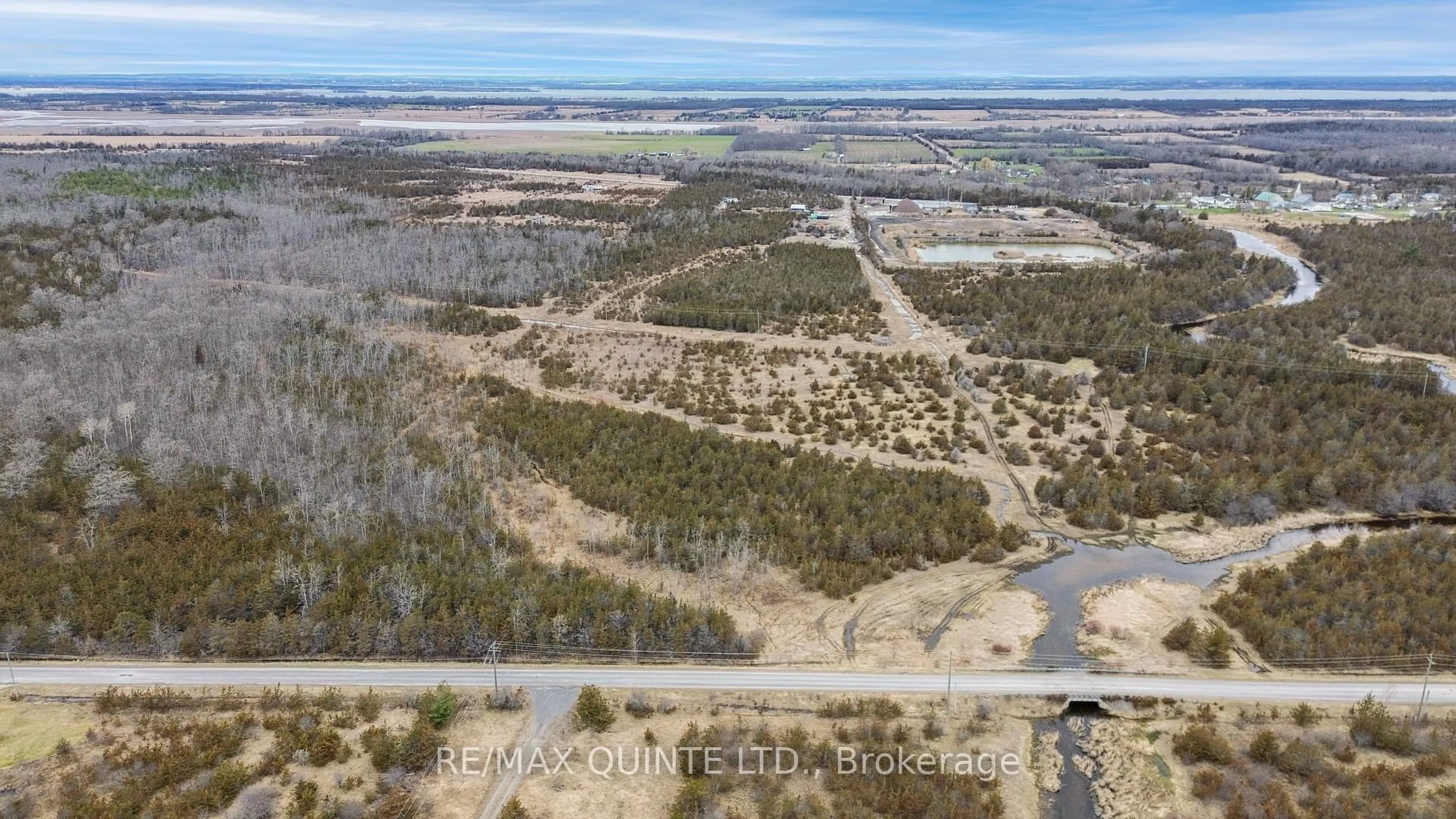 A pic from outside/outdoor area/front of a property/back of a property/a pic from drone, water/lake/river/ocean view for 55 County Road 14, Prince Edward County Ontario K0K 1W0