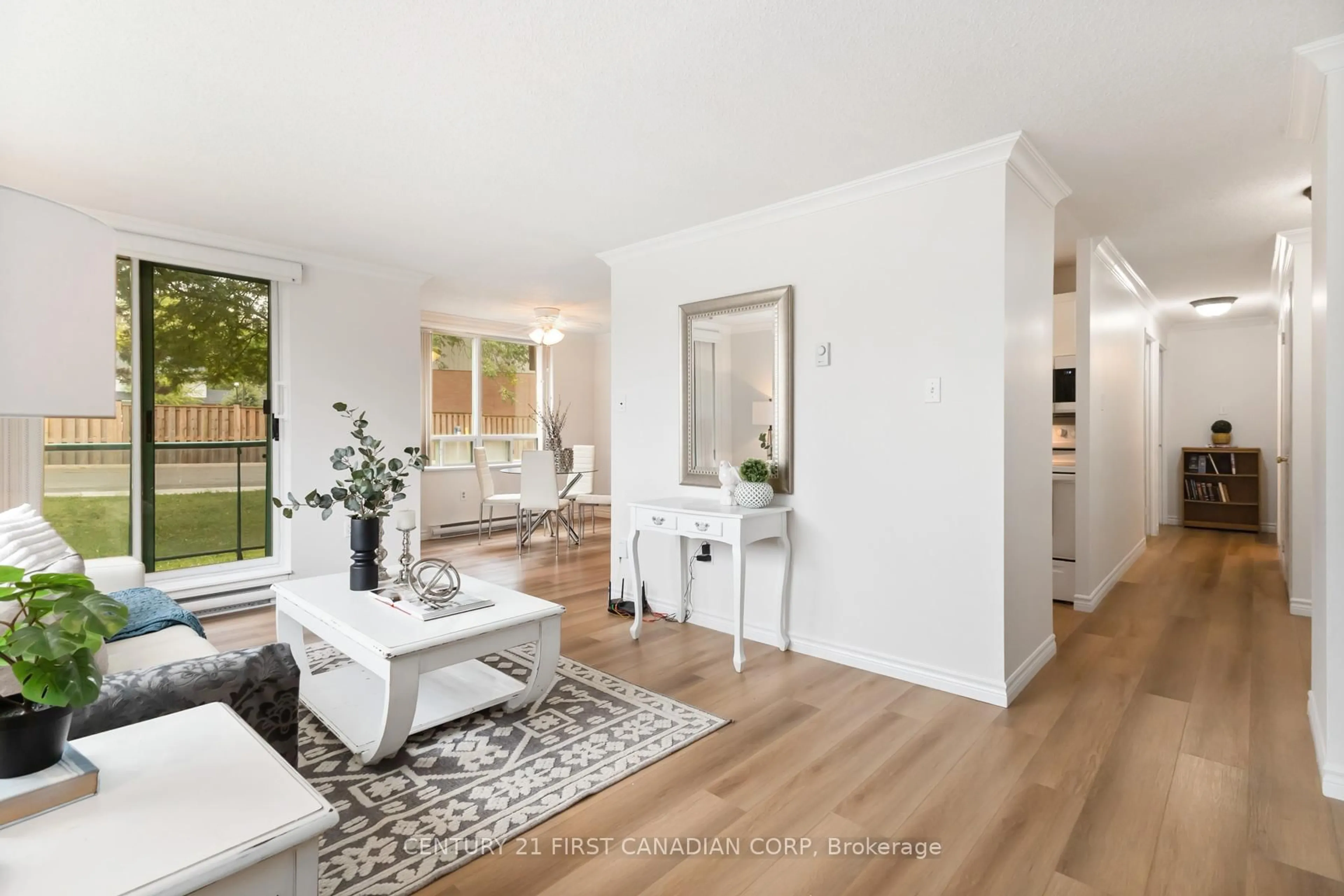 Living room with furniture, wood/laminate floor for 76 Base Line Rd #108, London South Ontario N6J 4X6