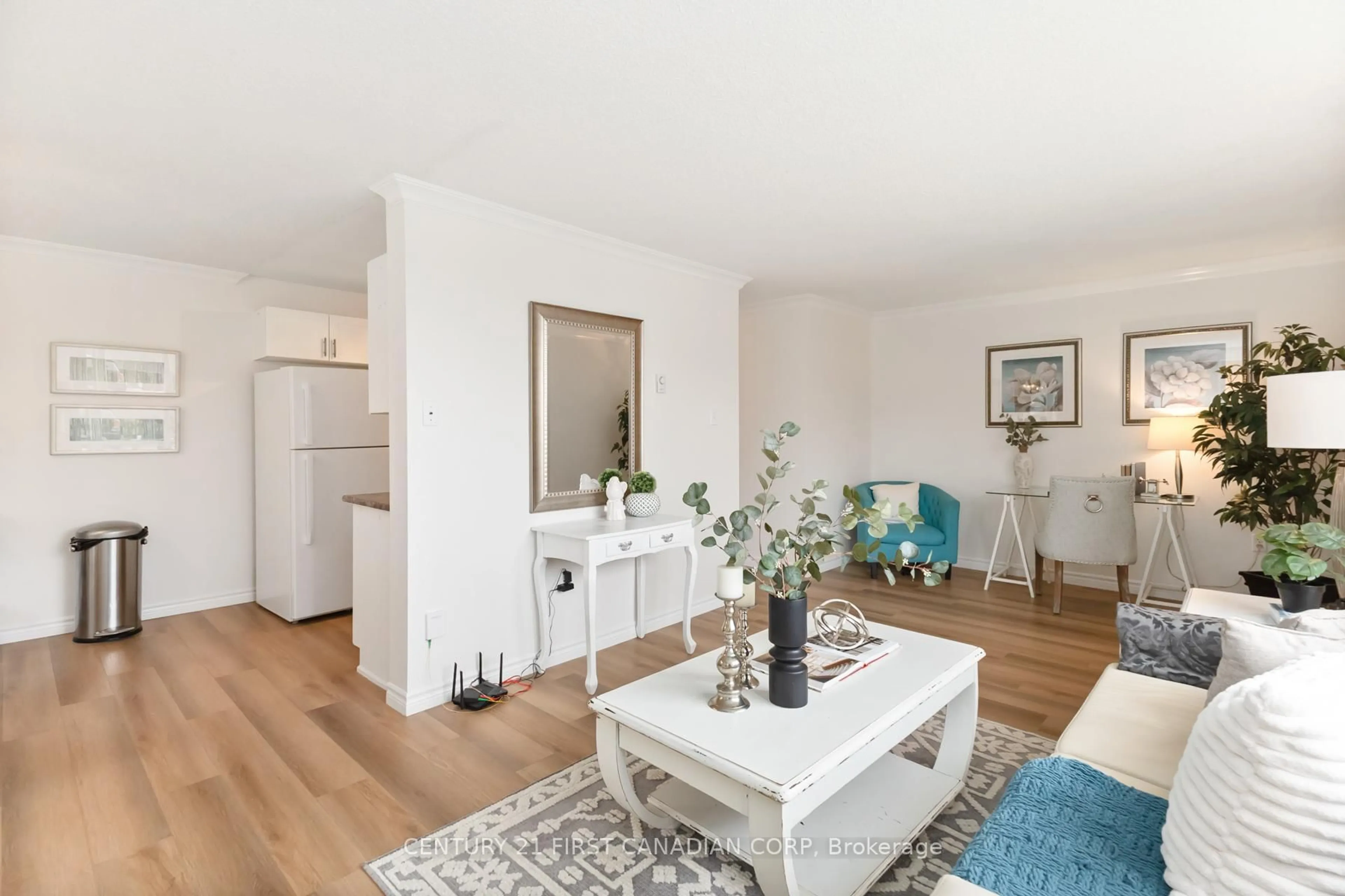 Living room with furniture, wood/laminate floor for 76 Base Line Rd #108, London South Ontario N6J 4X6