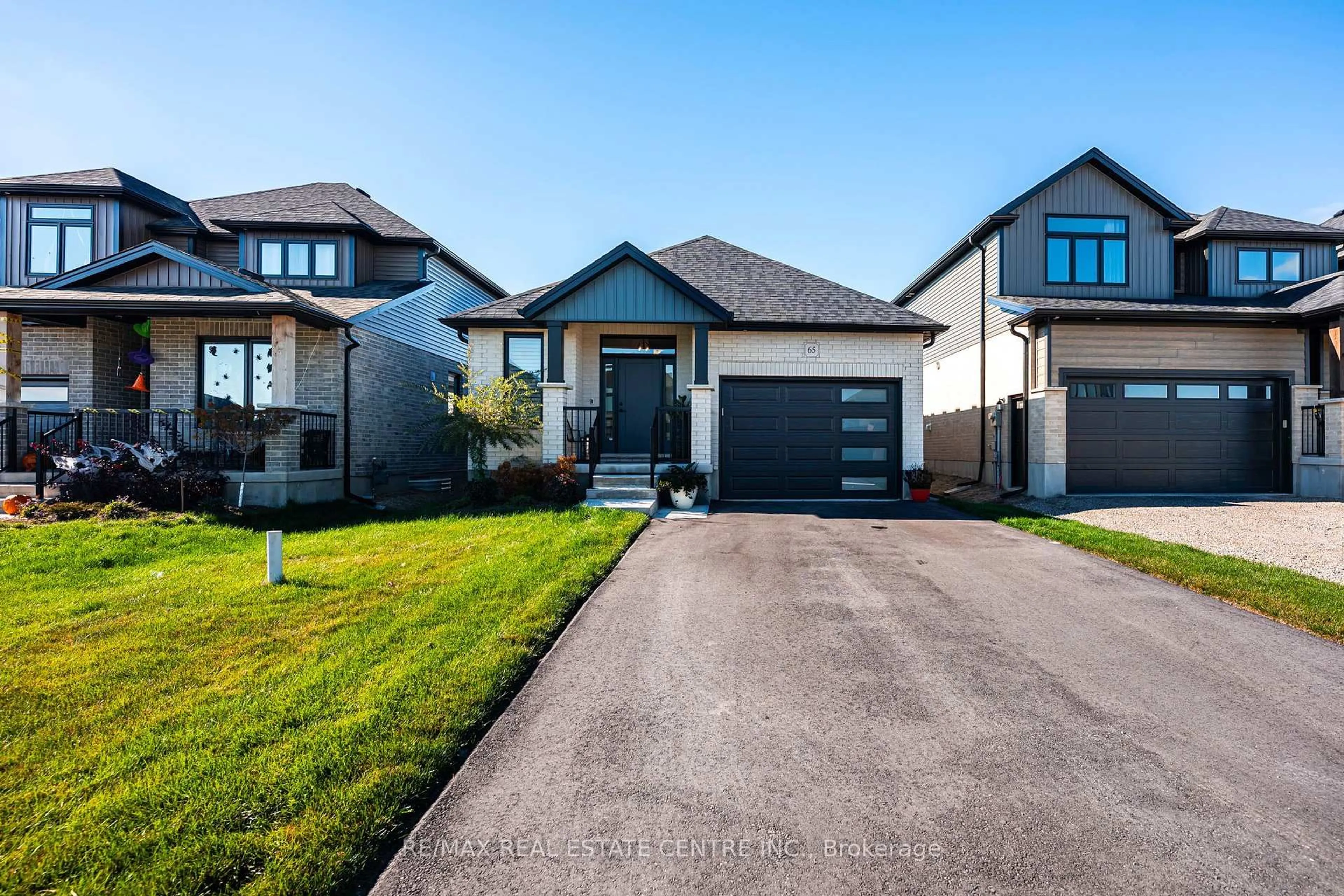 Home with brick exterior material, street for 65 Melody Lane, East Luther Grand Valley Ontario L9W 7V1