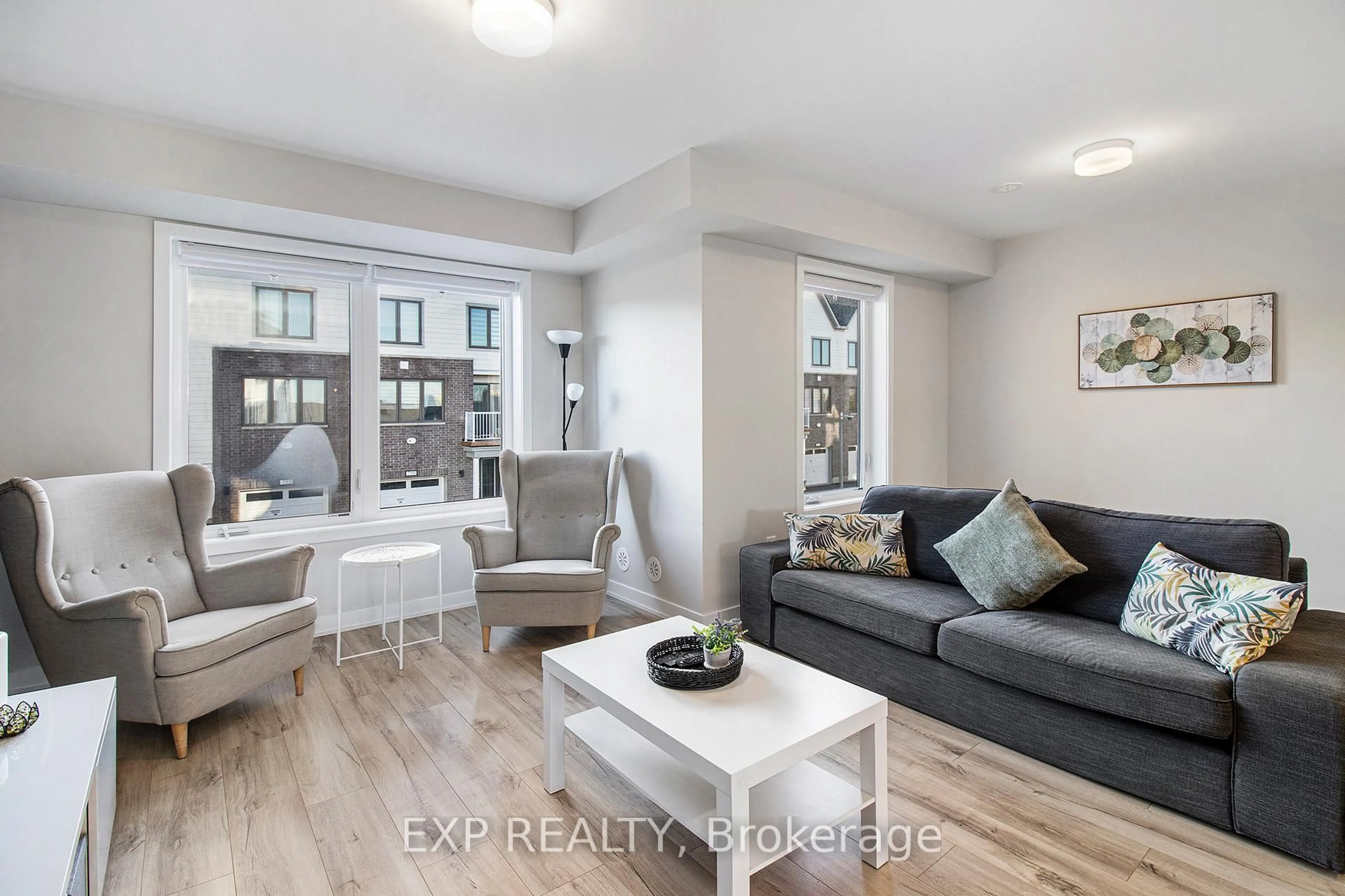 Living room with furniture, wood/laminate floor for 754 Kinstead Private, Ottawa Ontario K2S 3B3