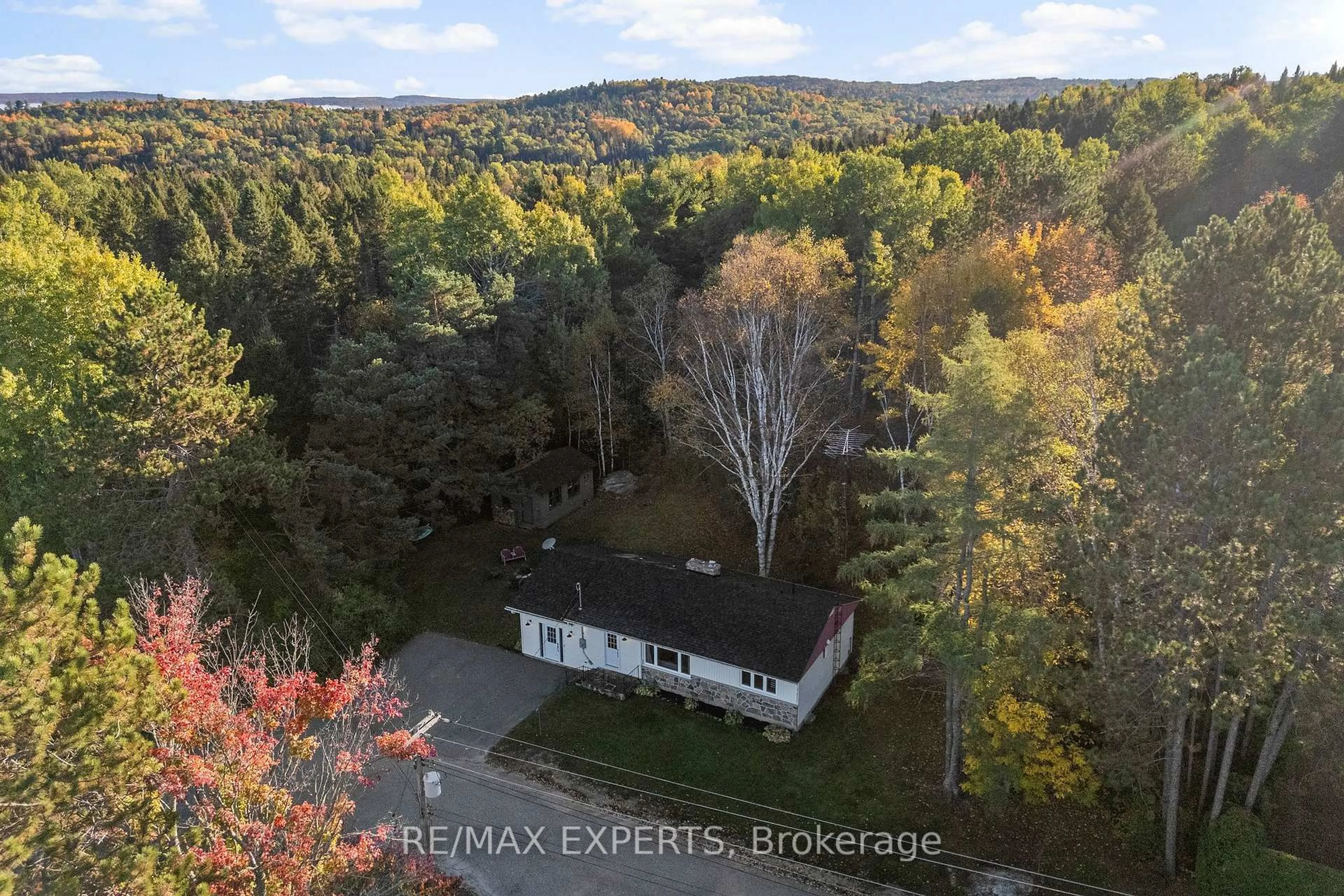 A pic from outside/outdoor area/front of a property/back of a property/a pic from drone, forest/trees view for 77 Post St, South Algonquin Ontario K0J 2M0