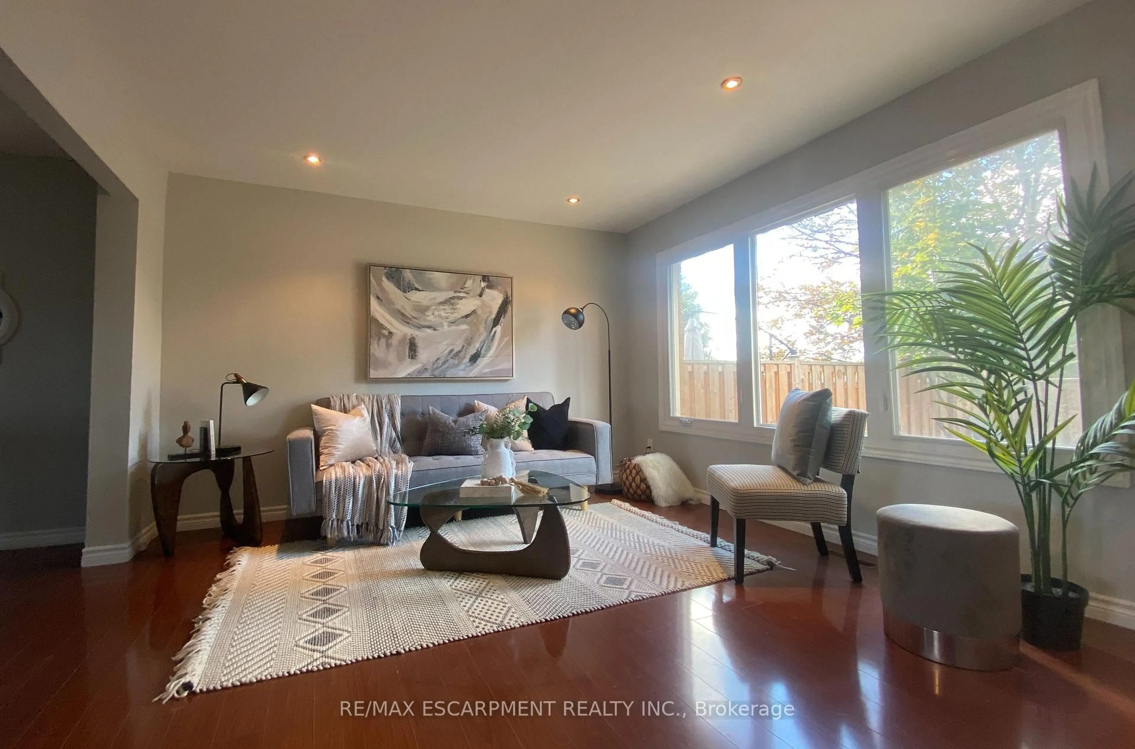 Living room with furniture, wood/laminate floor for 1025 Upper Gage Ave #3, Hamilton Ontario L8V 4L2