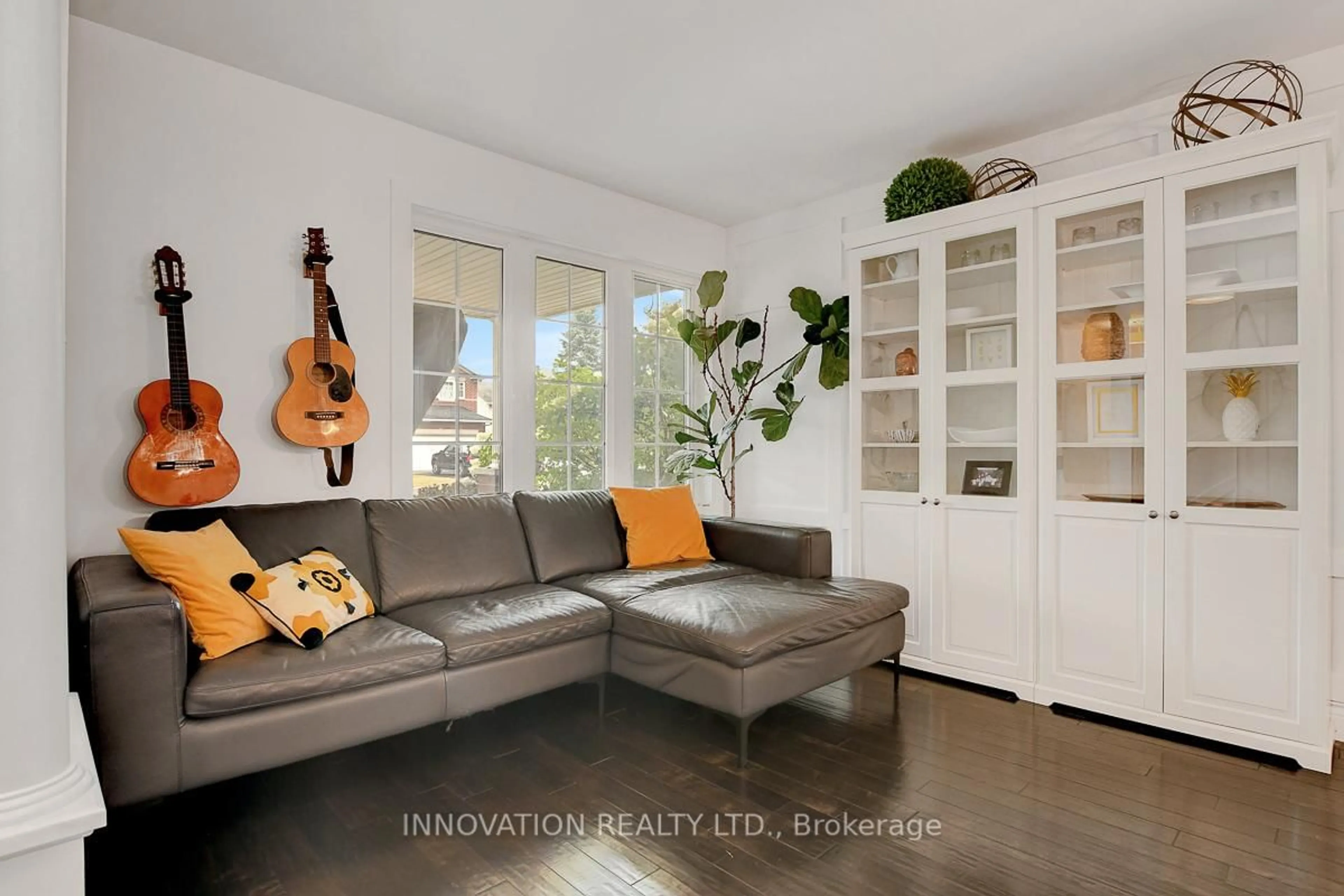 Living room with furniture, wood/laminate floor for 69 Smoketree Cres, Ottawa Ontario K2S 2B9