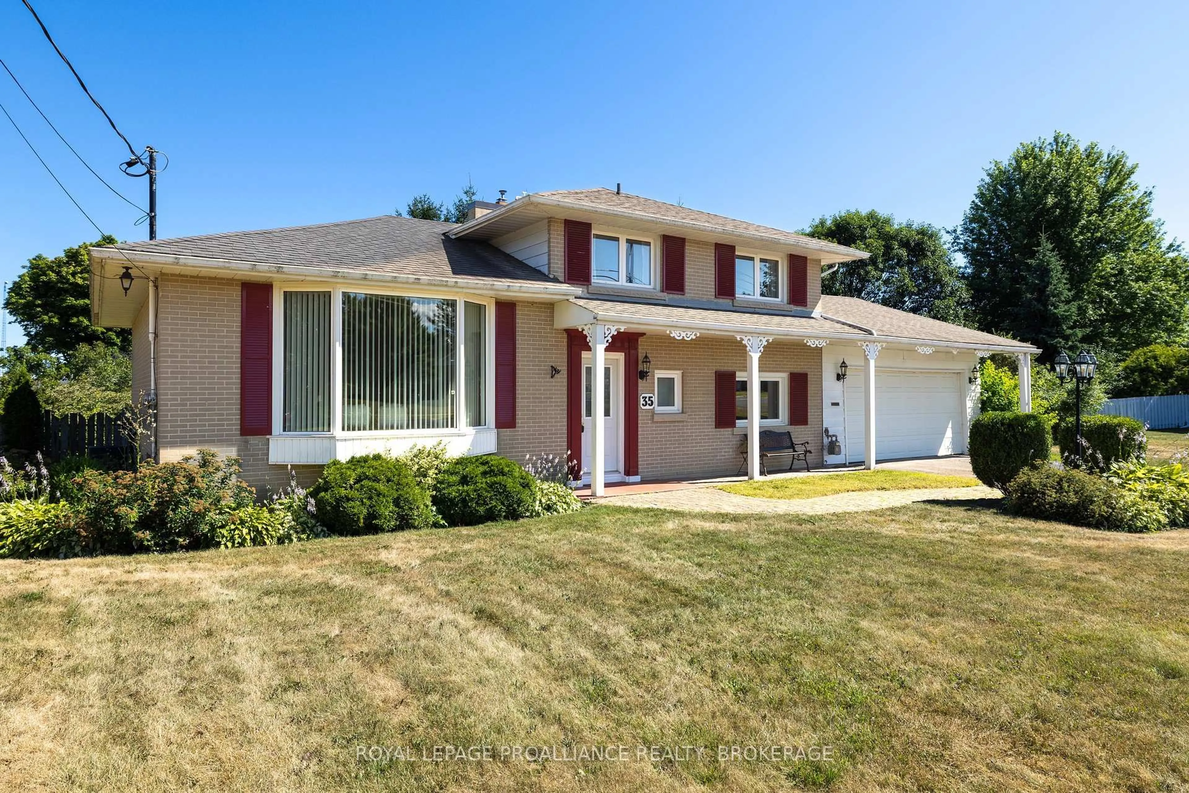 Home with vinyl exterior material, street for 35 Manitou Cres, Loyalist Ontario K7N 1B1