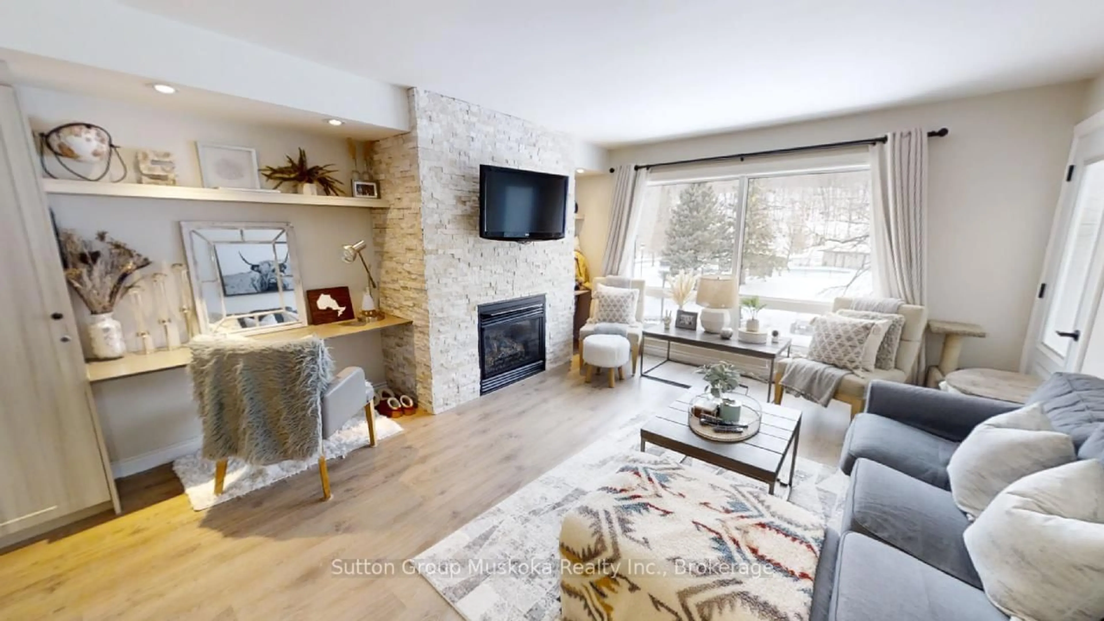 Living room with furniture, wood/laminate floor for 1235 Deerhurst Dr #52-308, Huntsville Ontario P1H 2E8