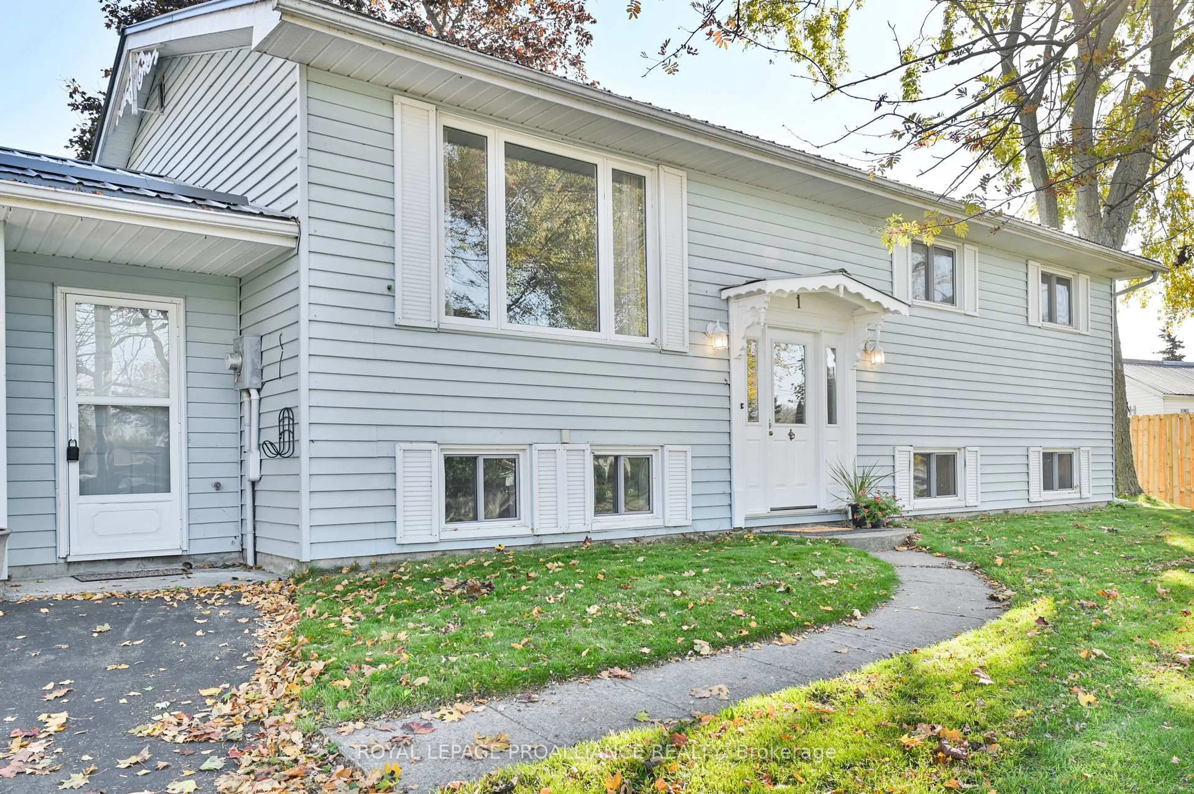 Home with vinyl exterior material, street for 1 Queen St, Brighton Ontario K0K 1H0