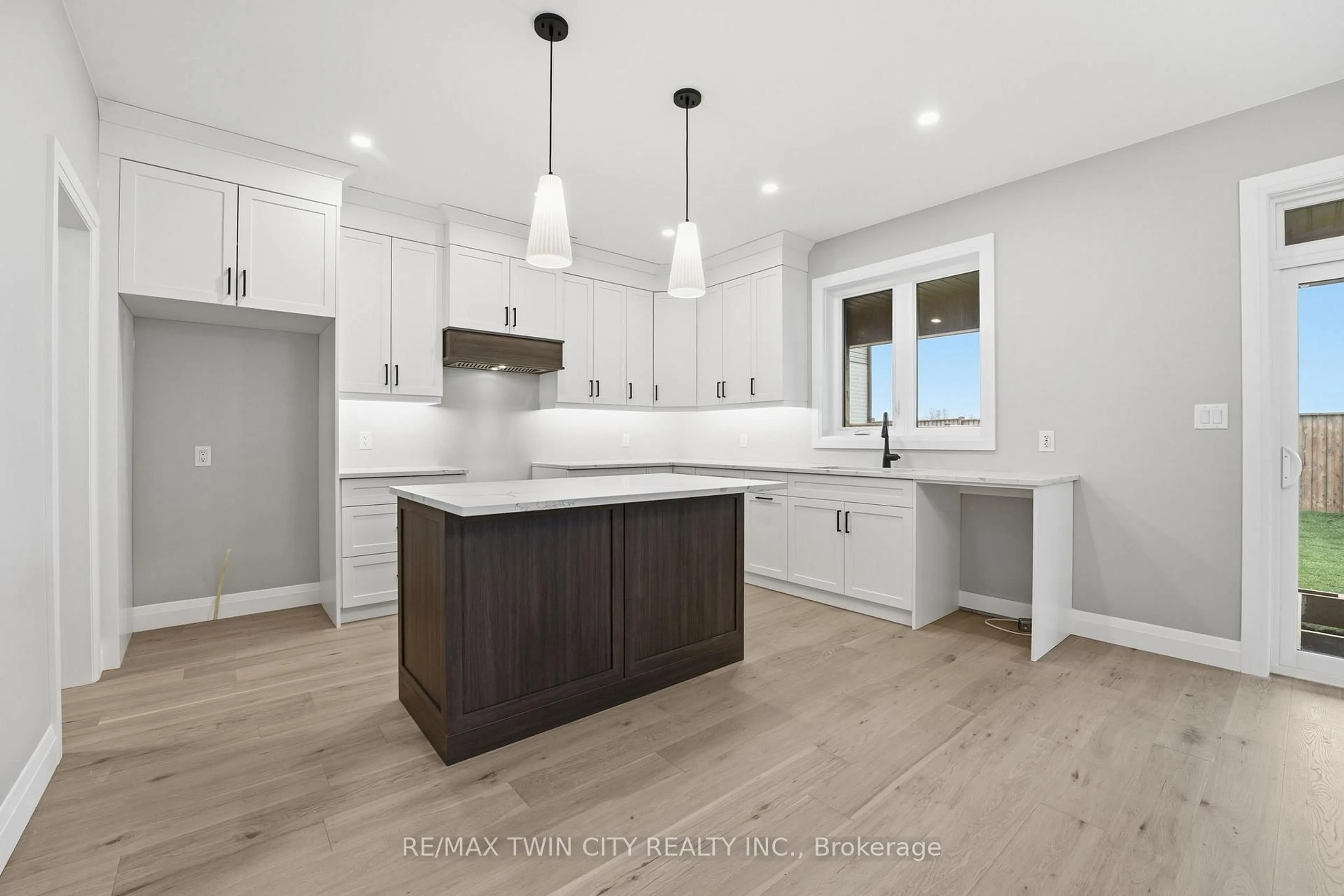 Open concept kitchen, wood/laminate floor for 104 Oak Ave, Brant Ontario N3L 0J6