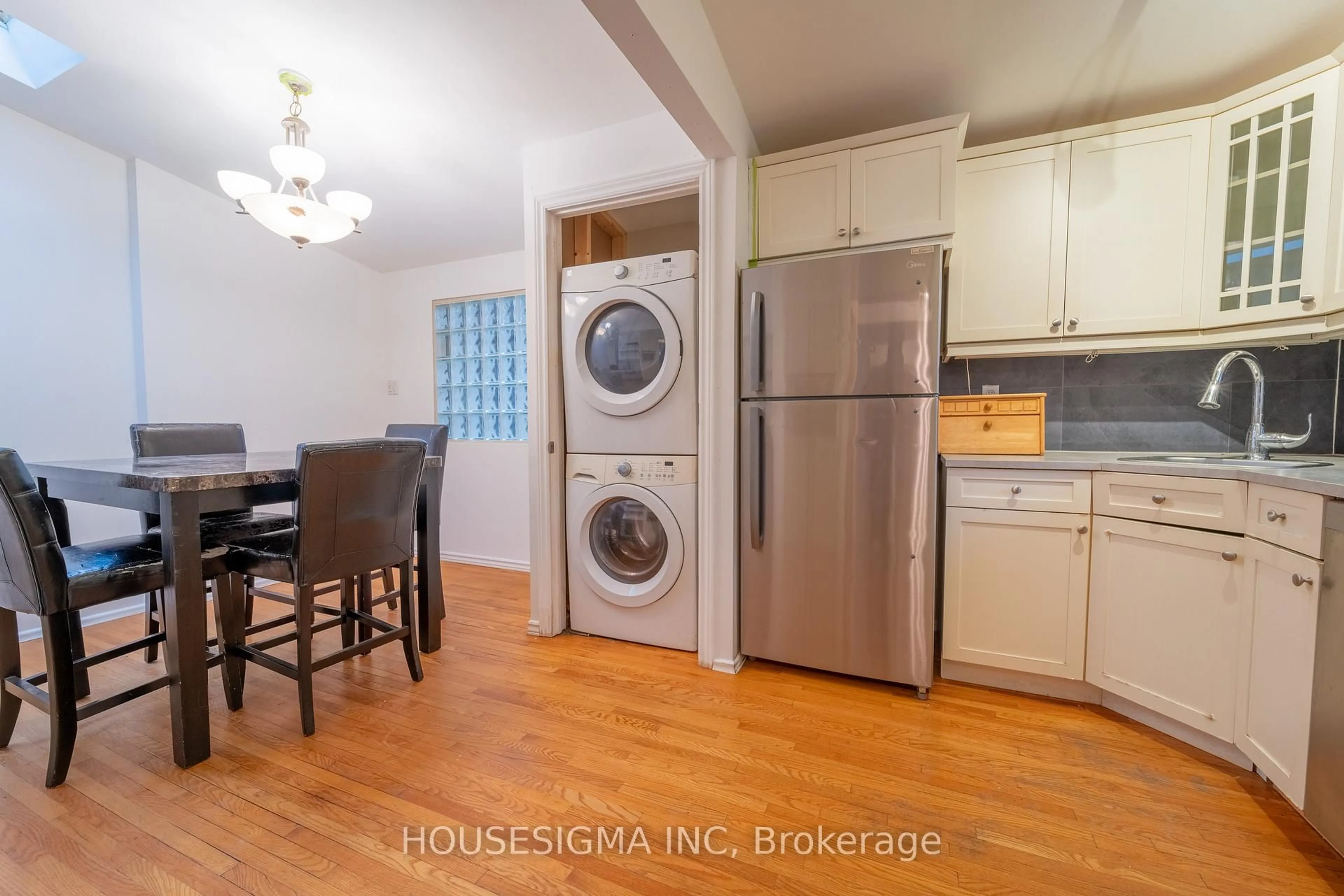 Kitchen with laundary machines, wood/laminate floor for 2335 Harding Rd, Ottawa Ontario K1G 3B7