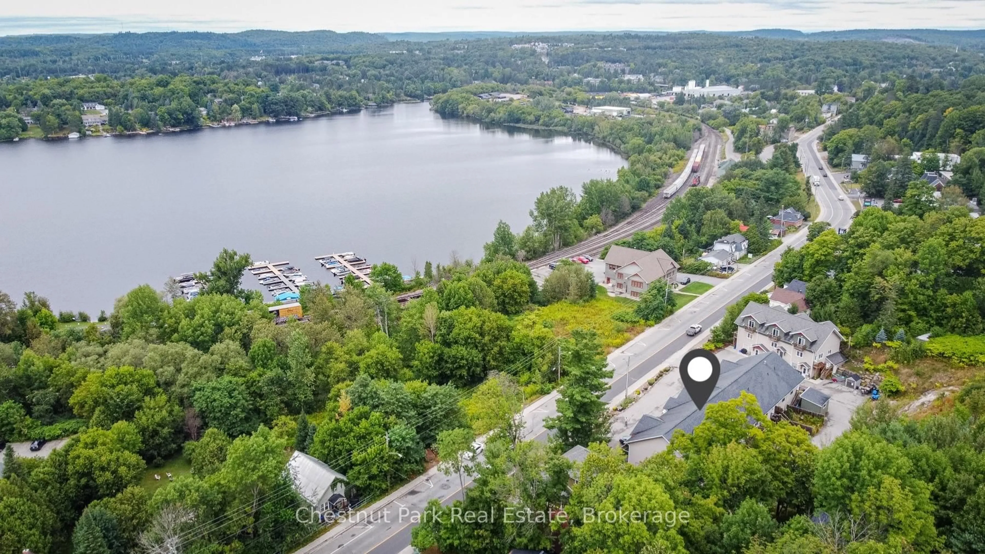 A pic from outside/outdoor area/front of a property/back of a property/a pic from drone, water/lake/river/ocean view for 99 Main St #5, Huntsville Ontario P1H 1X1