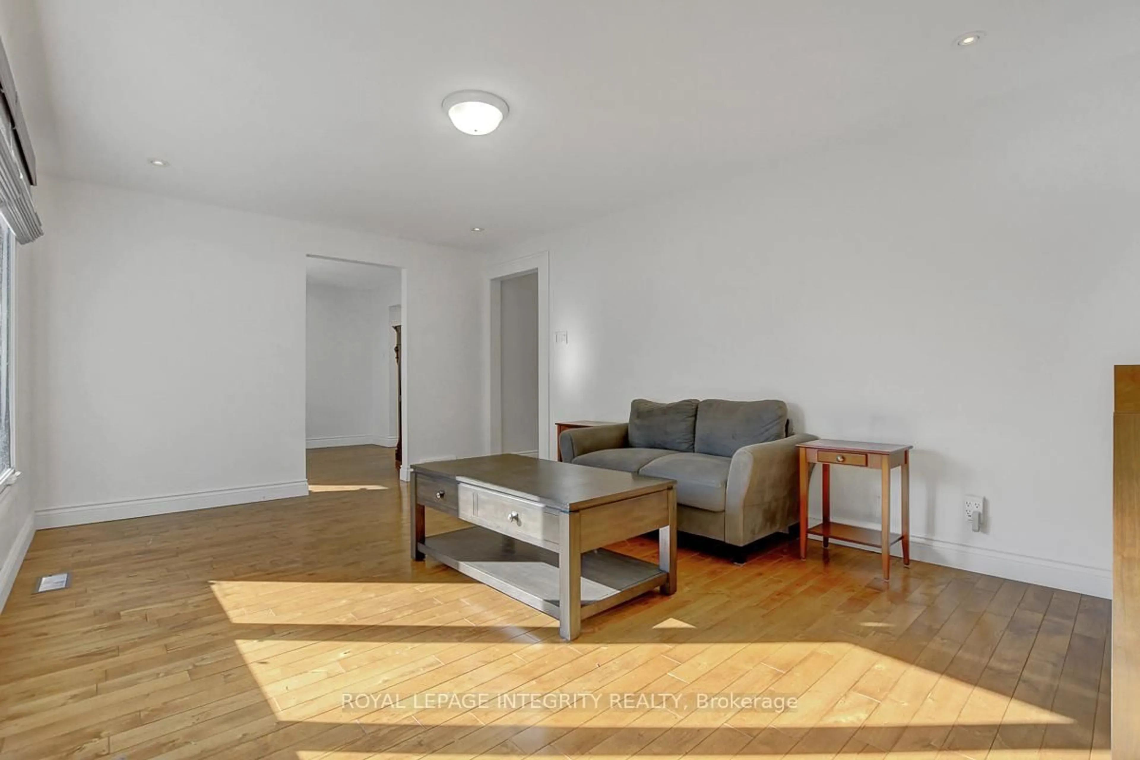 Living room with furniture, wood/laminate floor for 1142 Elmlea Dr, Ottawa Ontario K1J 6V9