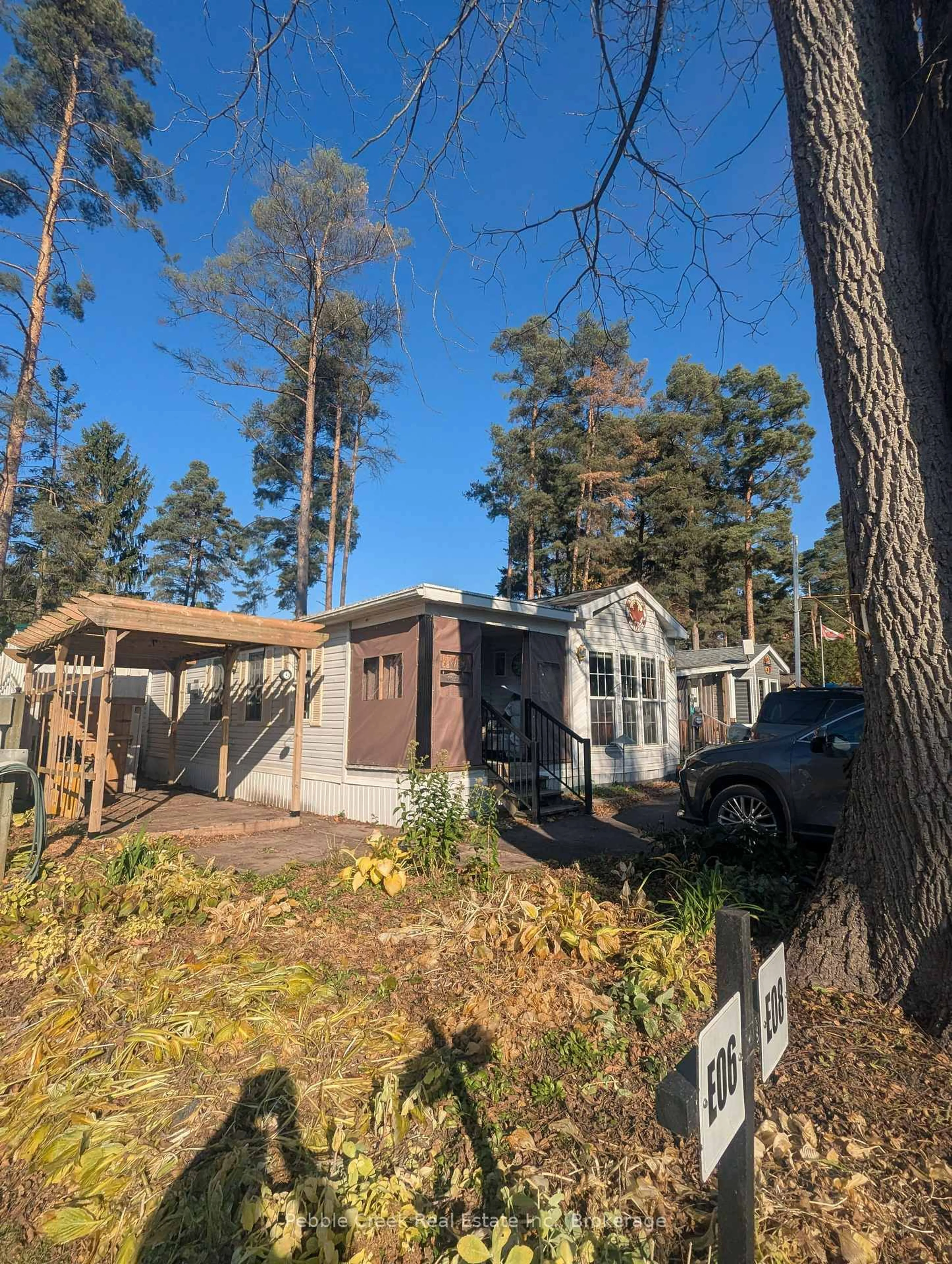 A pic from outside/outdoor area/front of a property/back of a property/a pic from drone, forest/trees view for 77794 Orchard Line #E8, Central Huron Ontario N0M 1G0