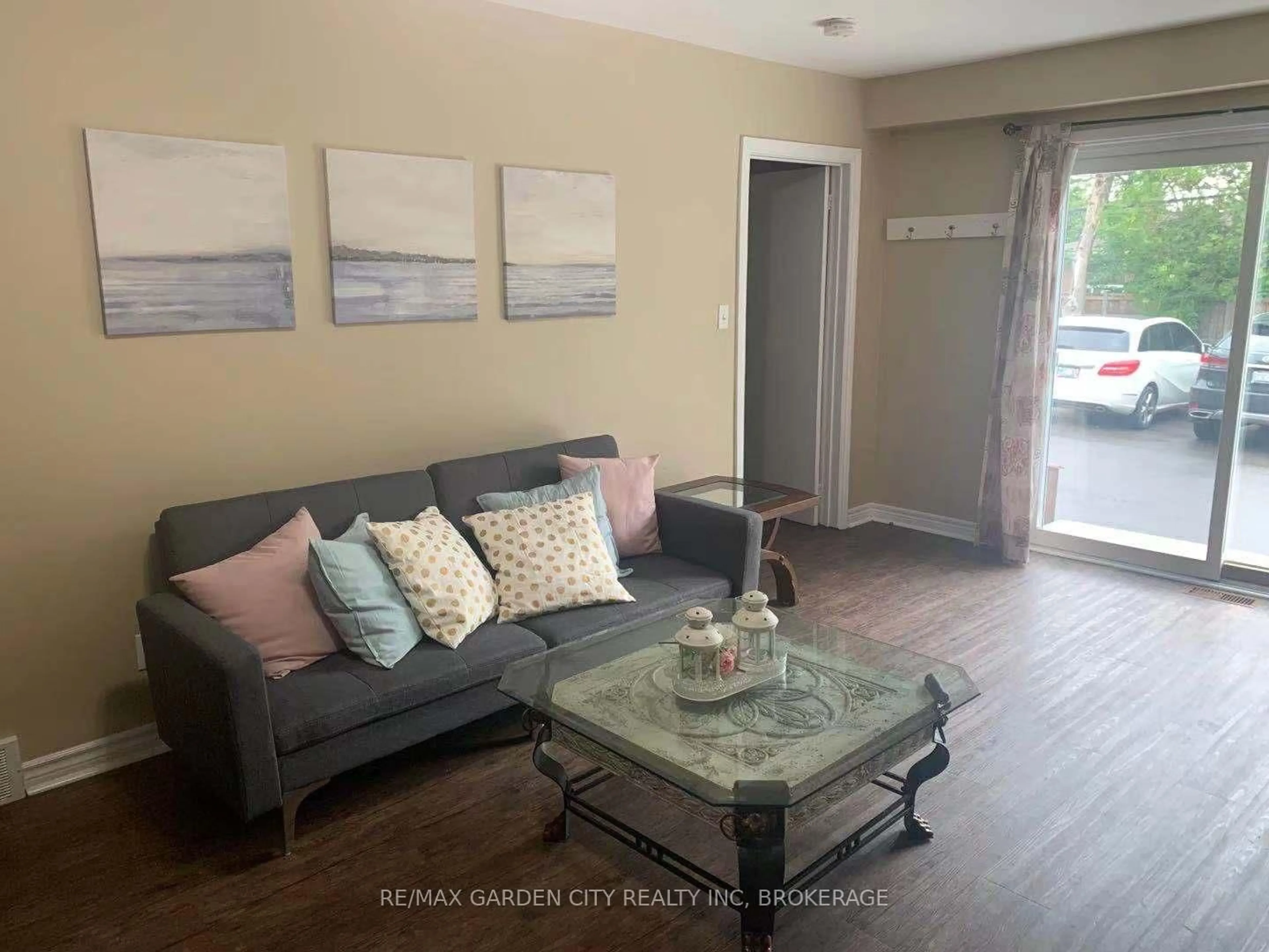 Living room with furniture, wood/laminate floor for 358-360 Glenridge Ave, St. Catharines Ontario L2T 3K7