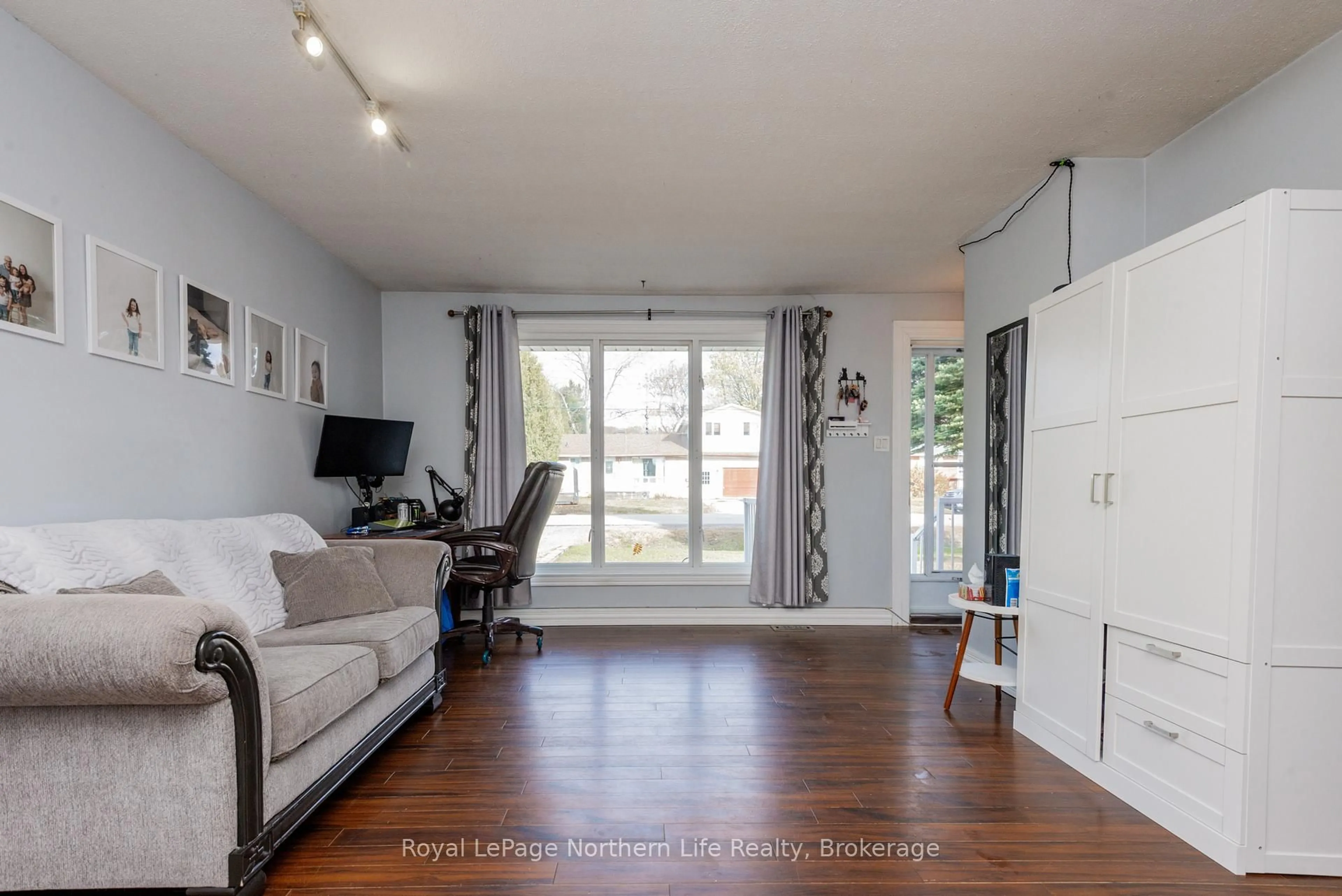 Living room with furniture, wood/laminate floor for 227 Terrace Lawn Dr, North Bay Ontario P1B 7P5