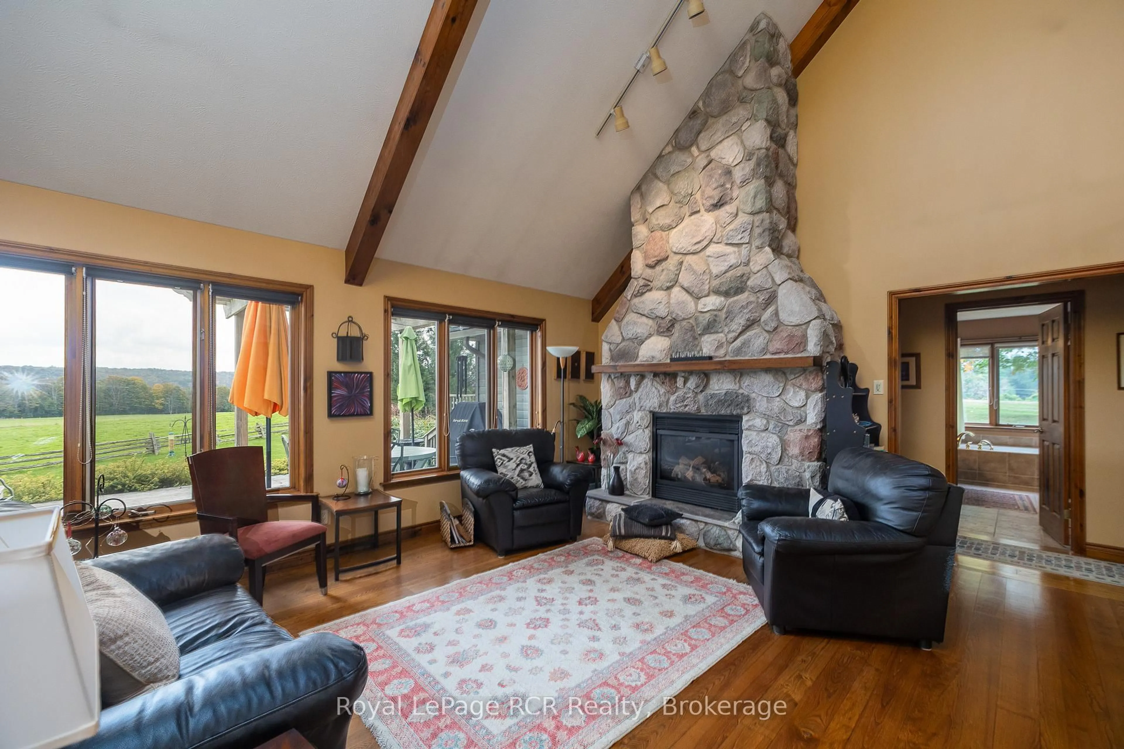 Living room with furniture, wood/laminate floor for 126010 13th Sideroad, Meaford Ontario N4L 1W6