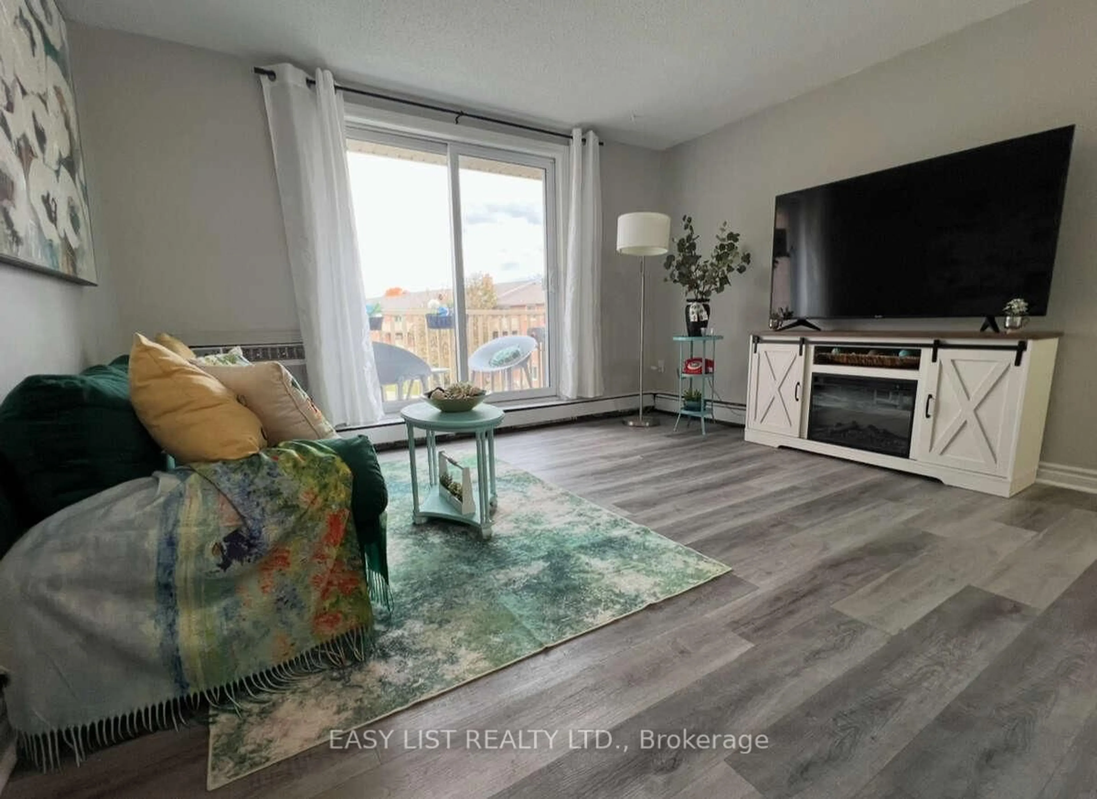 Living room with furniture, wood/laminate floor for 1582 Ernest Ave #304, London South Ontario N6E 2S4