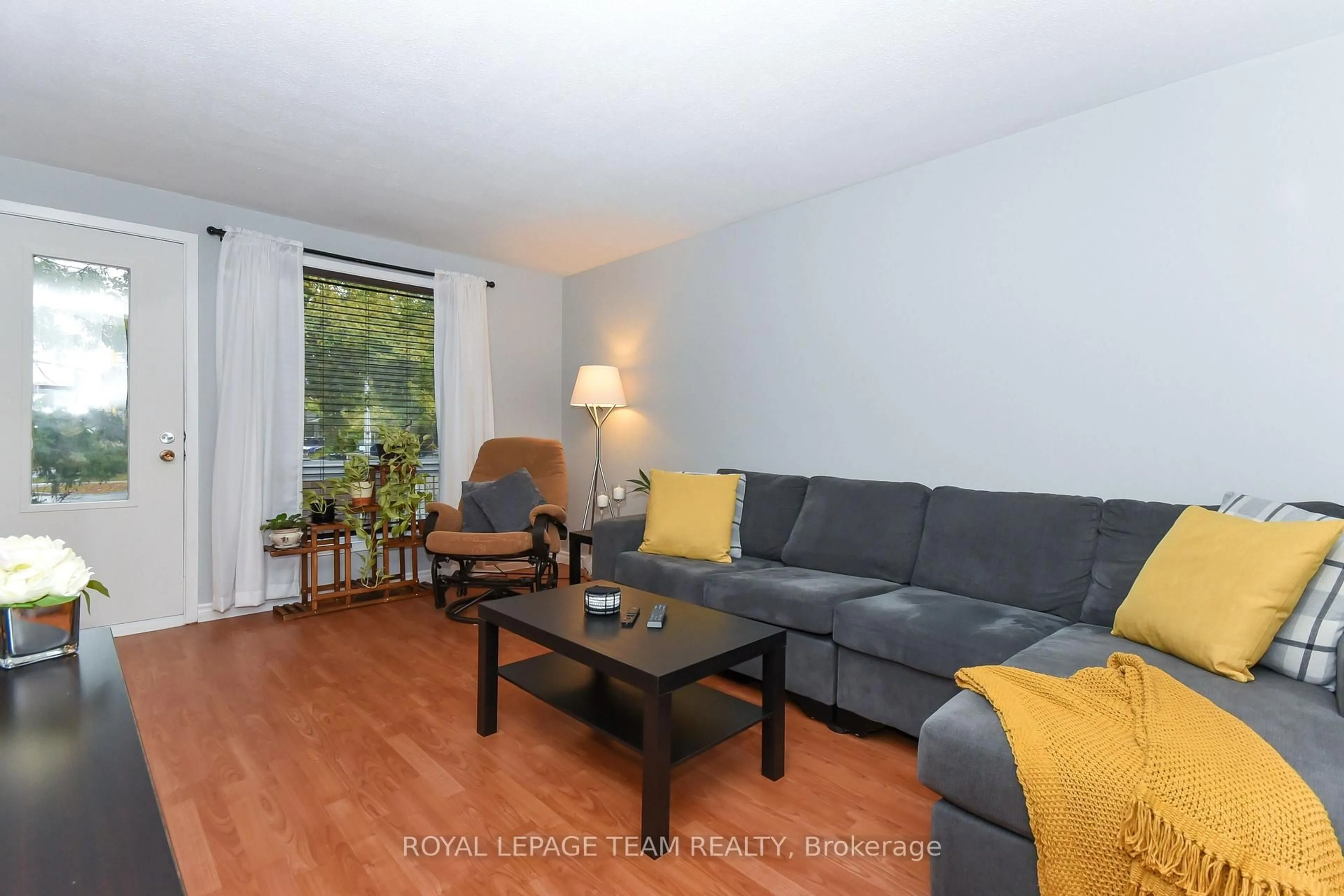 Living room with furniture, wood/laminate floor for 6993 Bilberry Dr #34, Orleans Ontario K1C 2C2